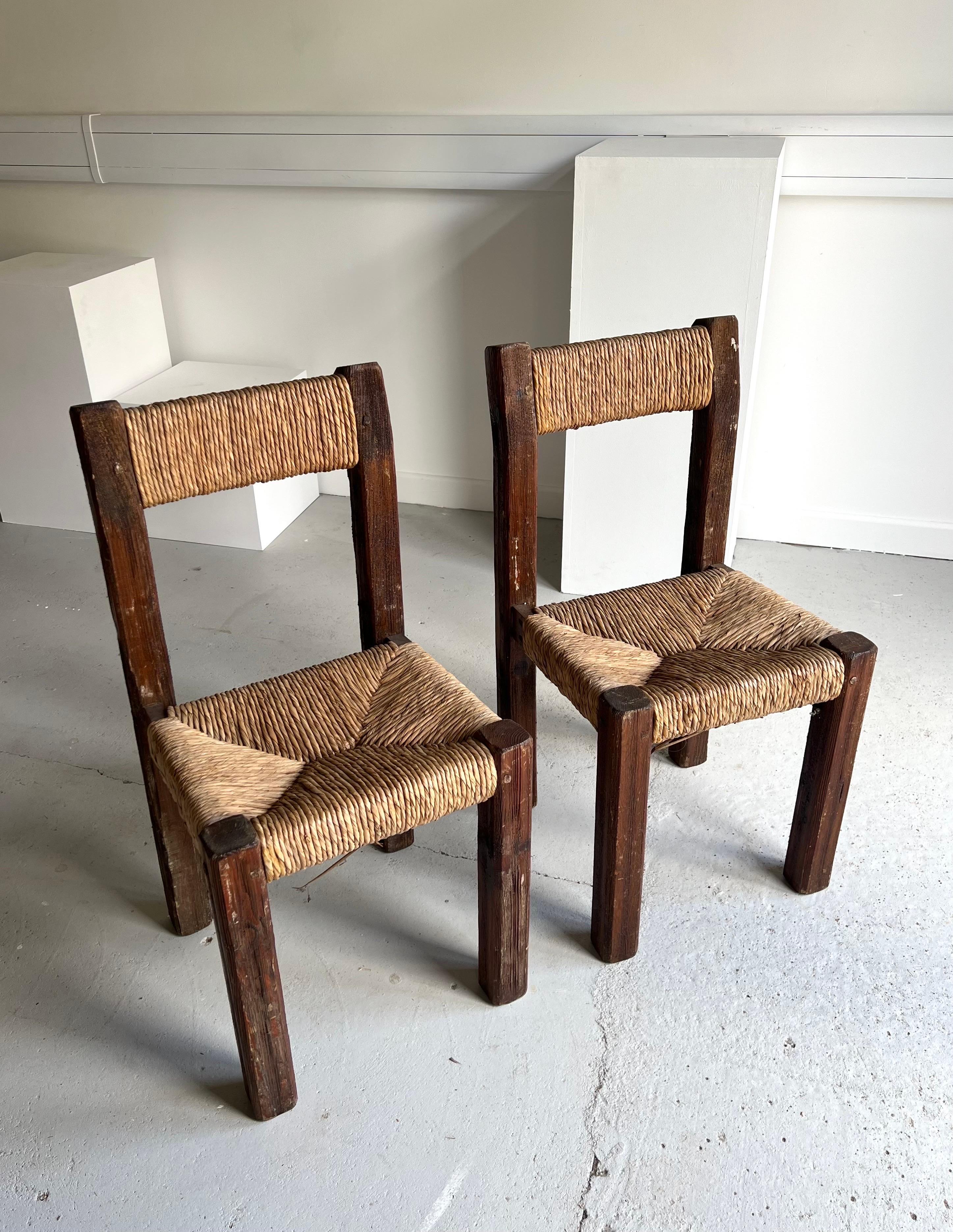 Pair of 1950s French Brutalist solid pine and straw chairs.  A rustic pair with rich texture, they would look fabulous in a classic or contemporary setting.  

There is some general wear however they remain structurally sturdy and the rush is in