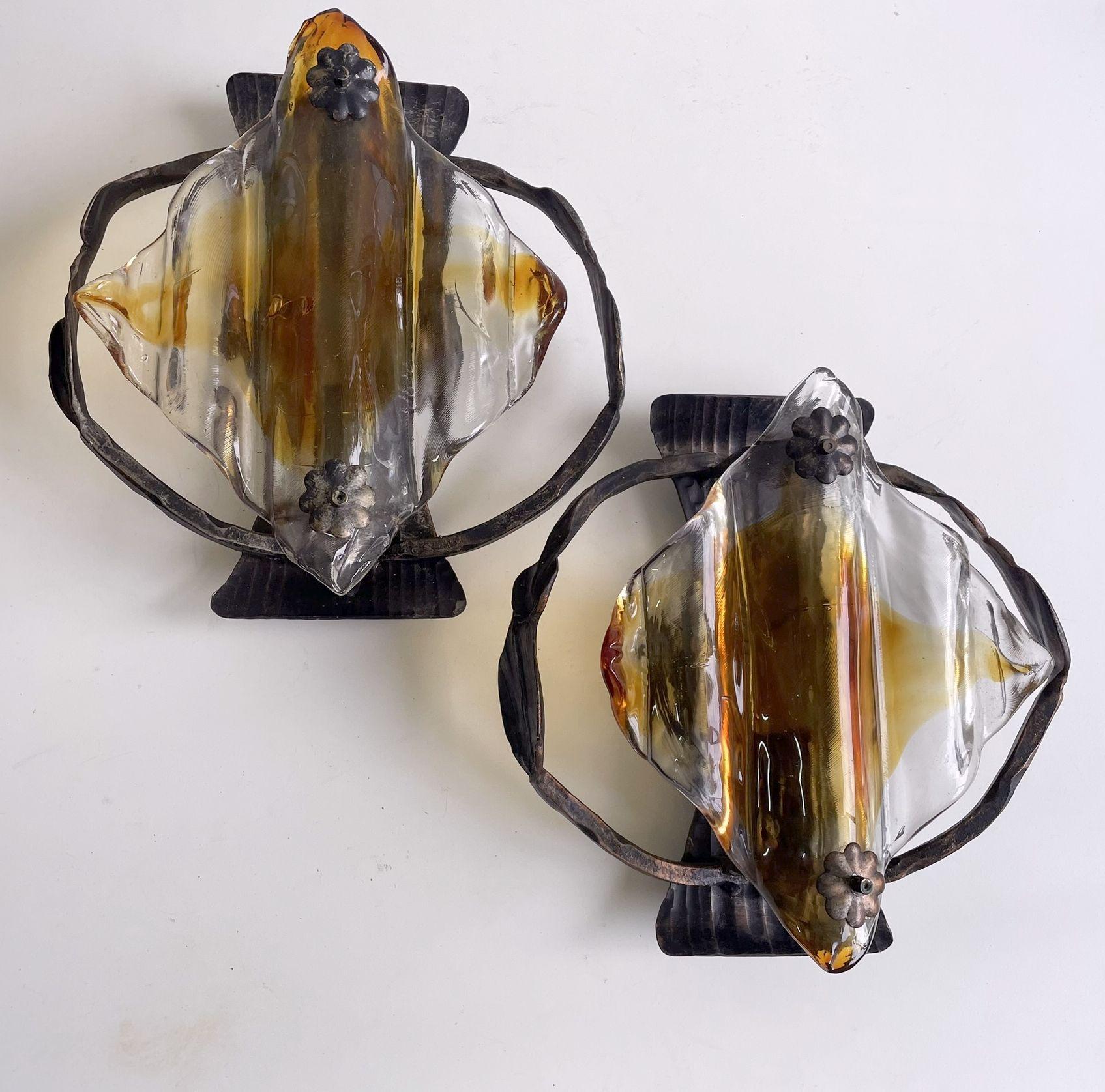 Solid construction made of iron and Murano glass. In the manner of Tom Ahlström and Marcello Fantoni.

The lamp will work with European E27 lightbulbs or the American E26 bulb. Works with old filament bulbs or LED filament bulbs, 220V for Europe and