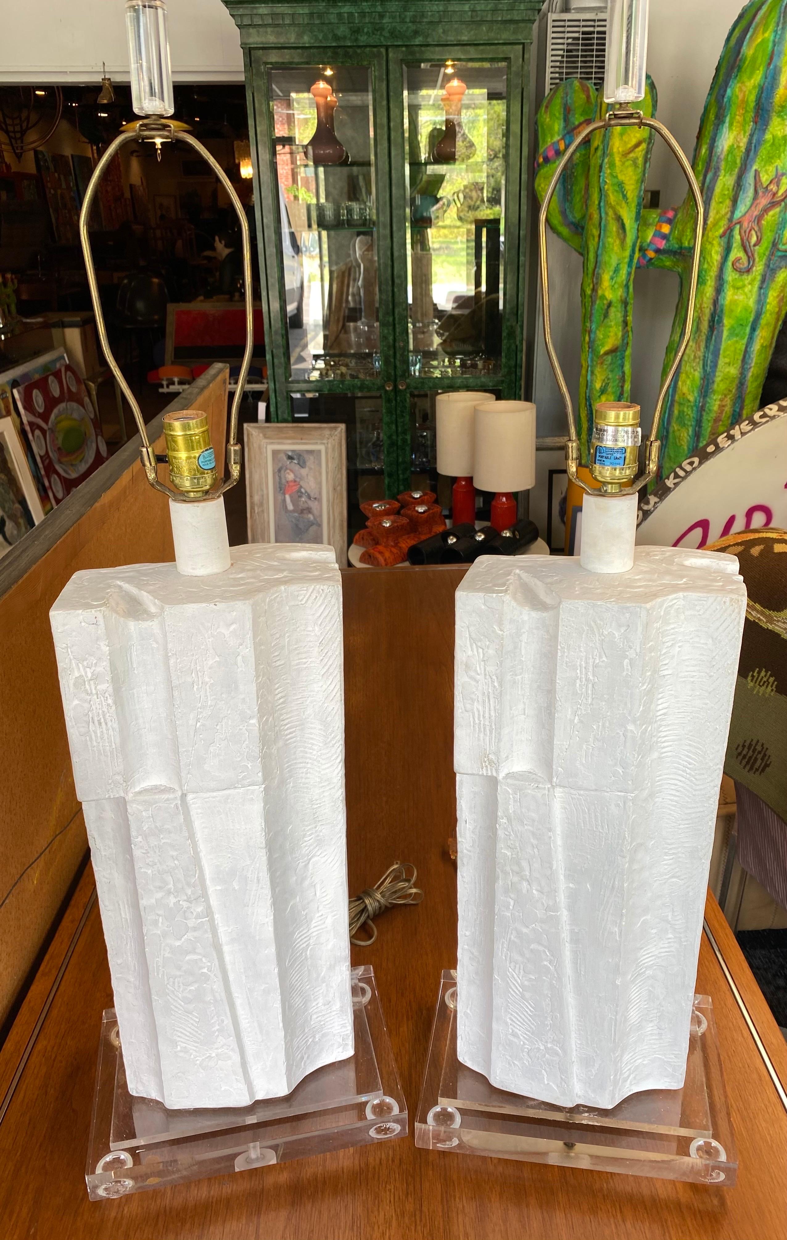 Nice pair of architectural brutalist lamps signed and dated, casual lamps of California, 1987. Lamps are cast plaster with an acrylic base. This pair of vintage lamps are in good vintage condition. 

Measures: 11”W x 37” H 7.50”D.
