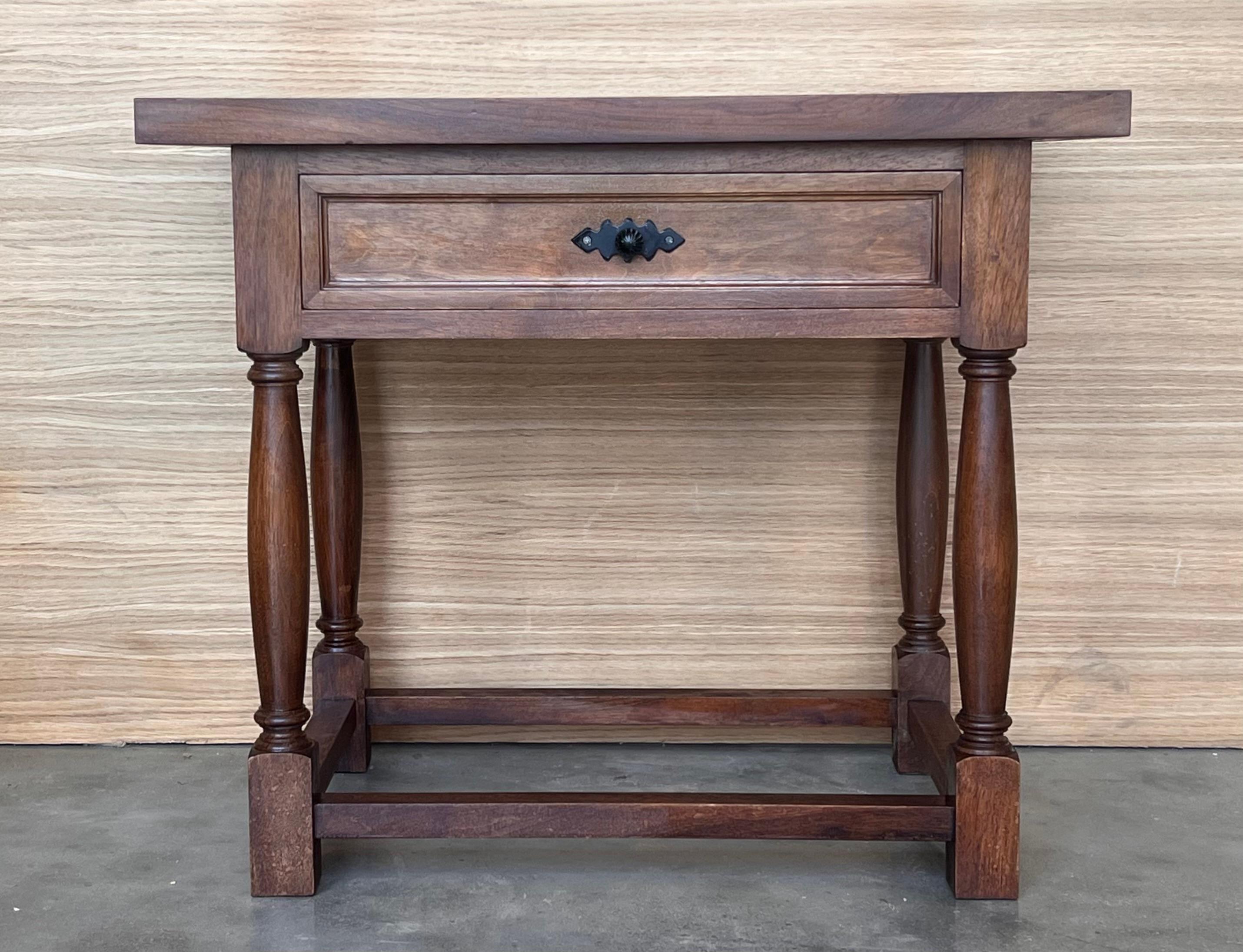 20th century Pair of Spanish nightstands or large low tables with one drawer , iron hardware and low shelve. The table has beautiful carved drawers with original iron pull and really nice patina.
 Beautiful tables that you can use like a nightstands