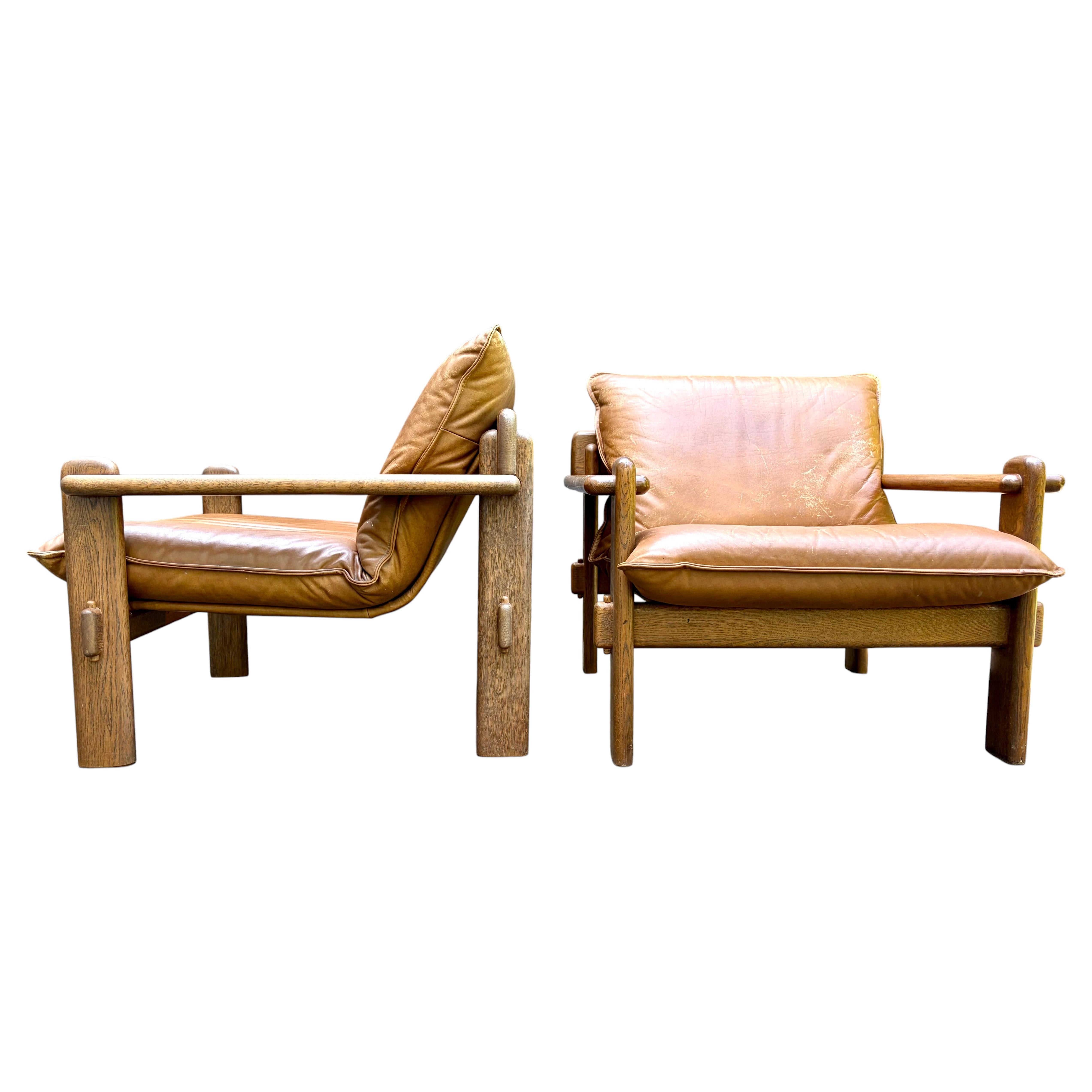 Pair of Brutalist Leather & Wood Armchairs in the style of Jean Gillon, 1960's