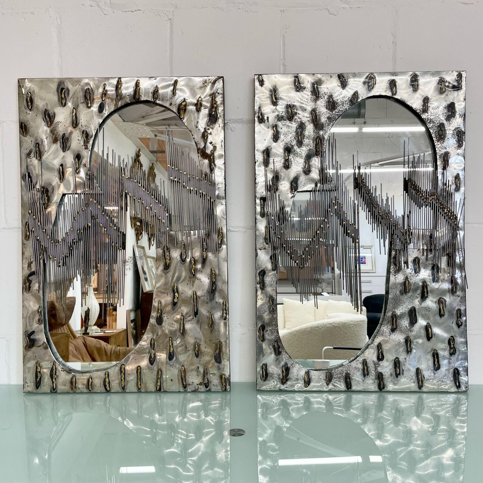 Pair of Brutalist Mid-Century Modern Paul Evans Style Mirrors, Wall / Console
 
Studio made artisan mirrors with welded rods and intricate brutalist detail. Two mirrors are available - the pair can be split.
 
Steel, Glass
American, c. 2000s
 
35.5H