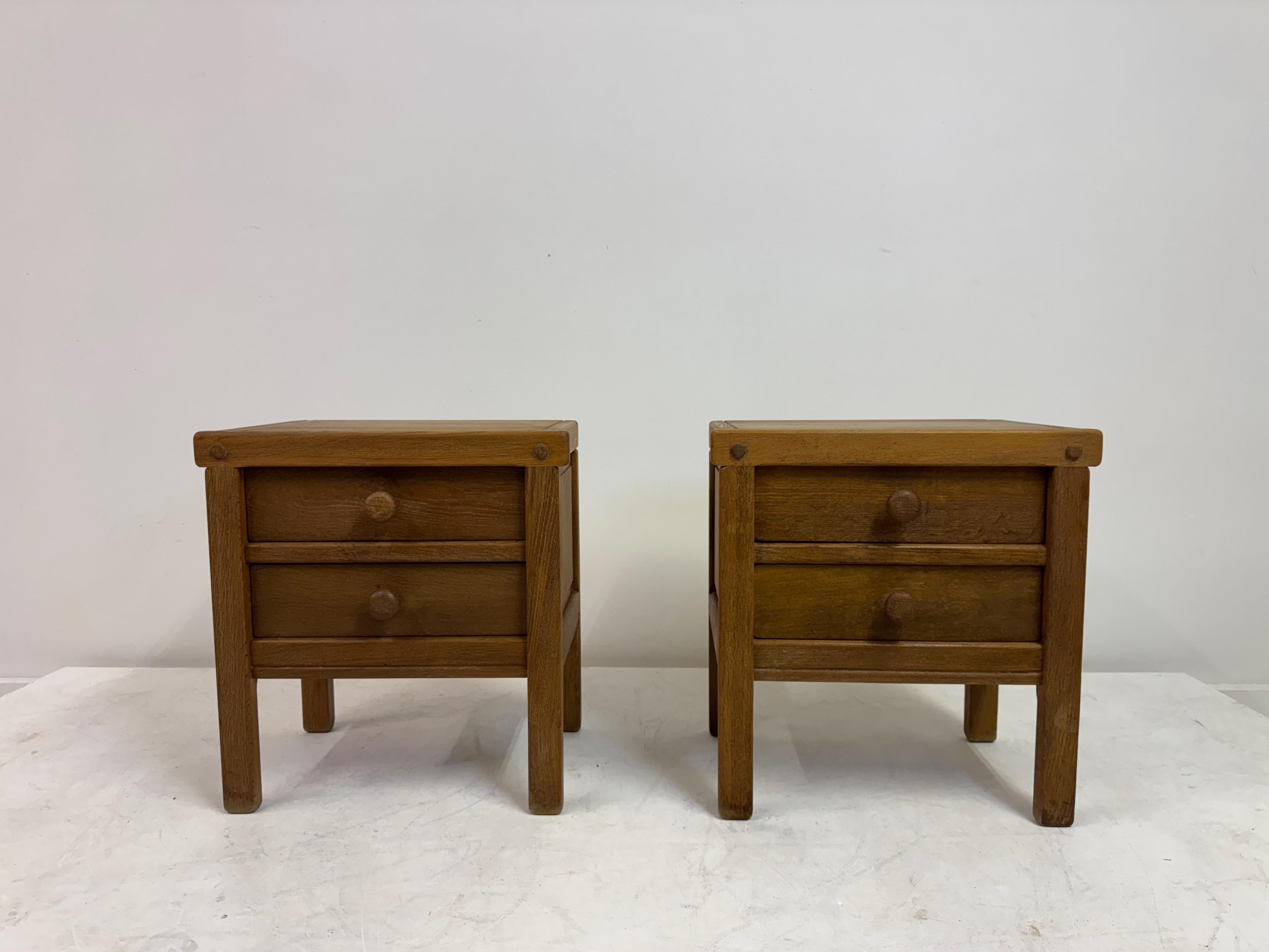 Pair of Brutalist Oak Bedside Cabinets, 1970s

A charming pair of 1970s Brutalist bedside cabinets in solid oak, each with two neatly proportioned drawers and simple turned wooden pulls. The construction is honest and quietly architectural: rounded
