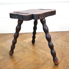 Pair of brutalist oak tripod milking stools.