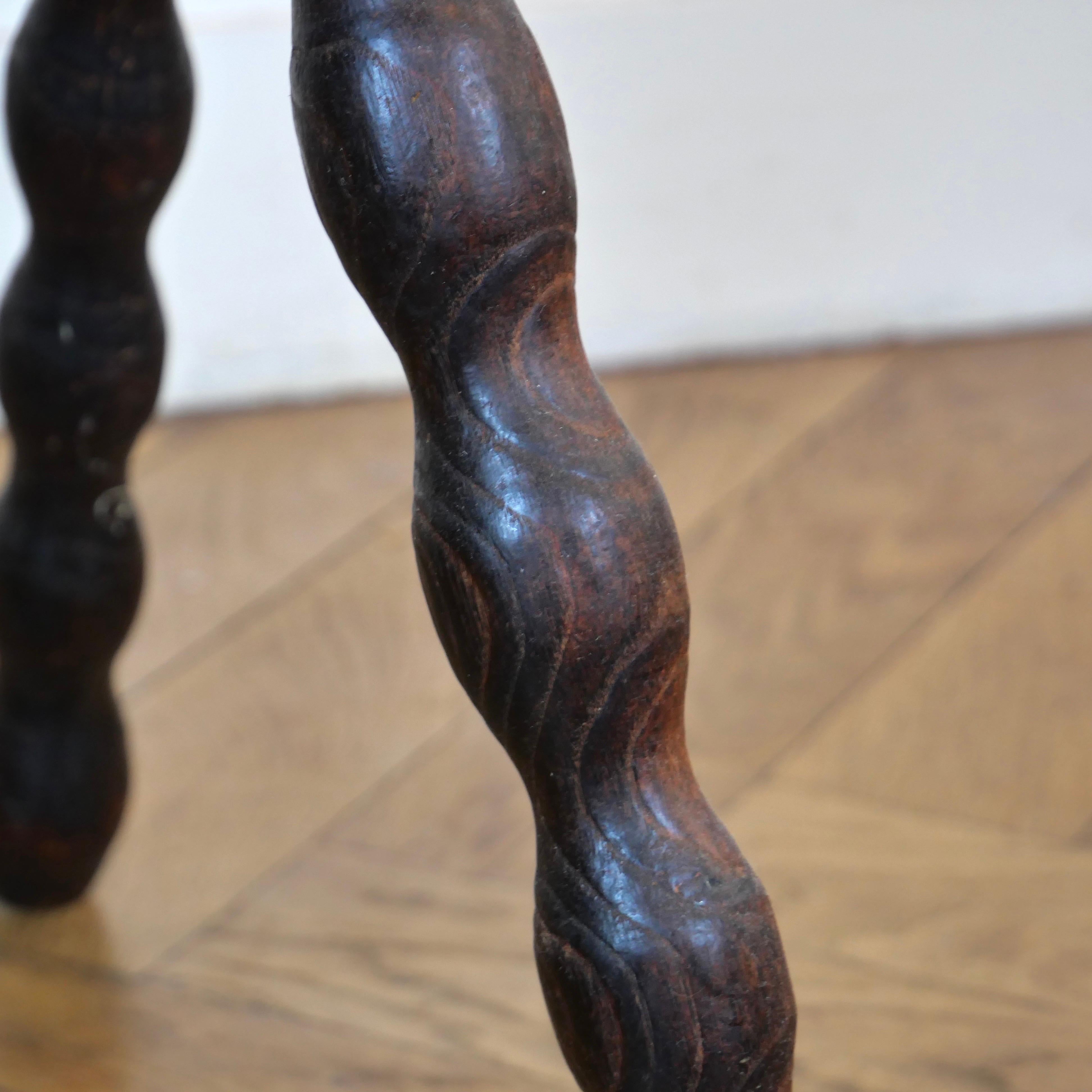 Mid-20th Century Pair of brutalist oak tripod milking stools.