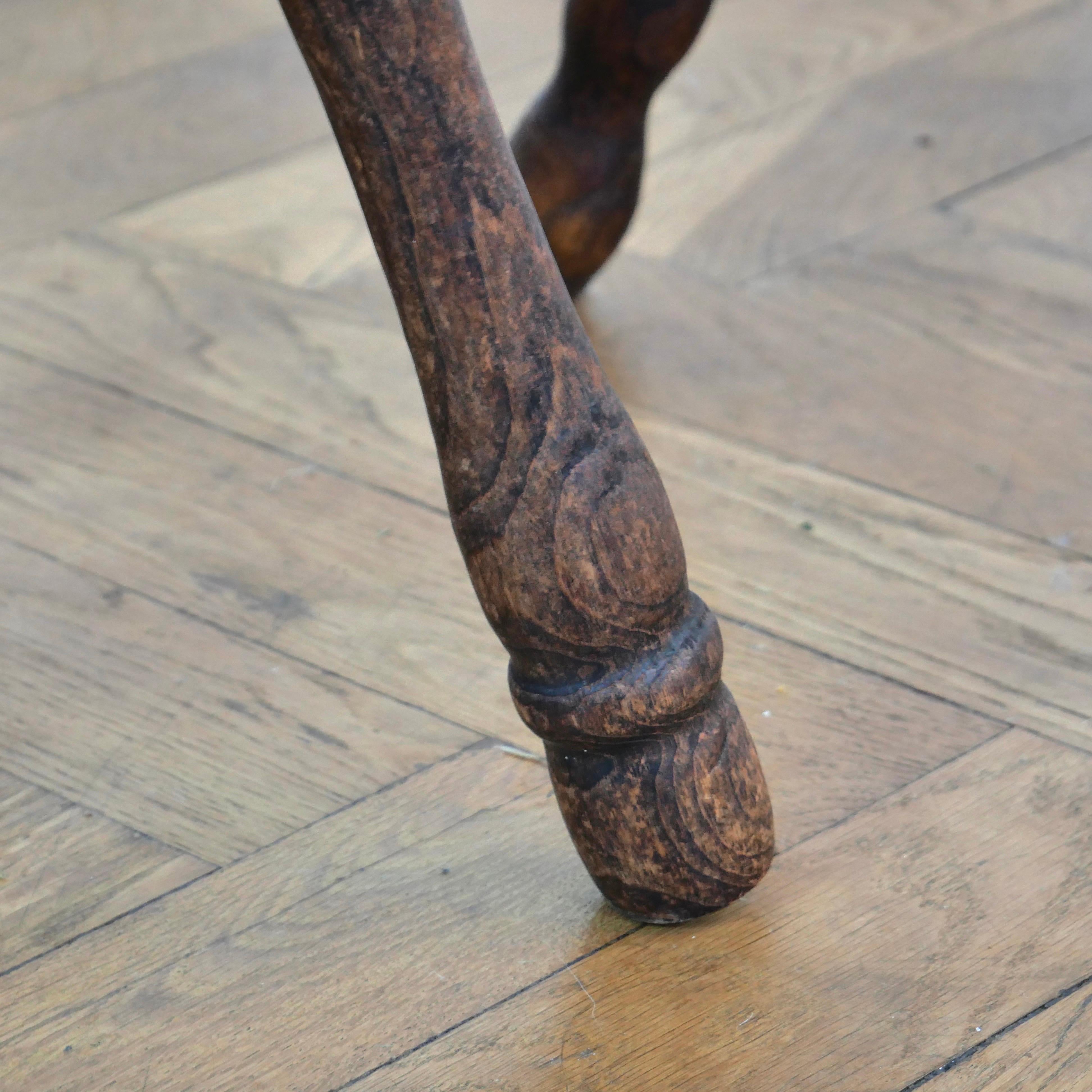 Oak Pair of brutalist oak tripod milking stools.