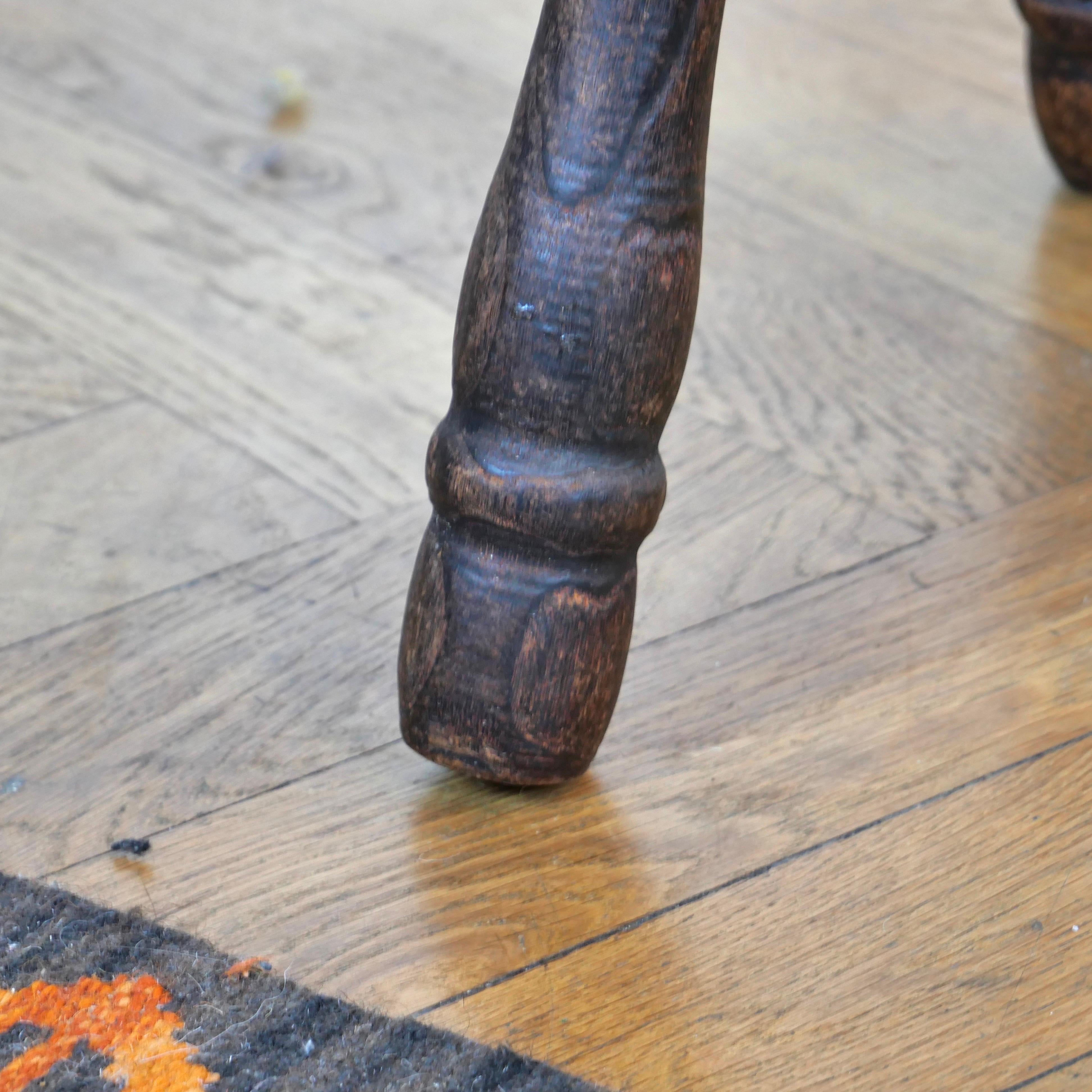 Pair of brutalist oak tripod milking stools. 1