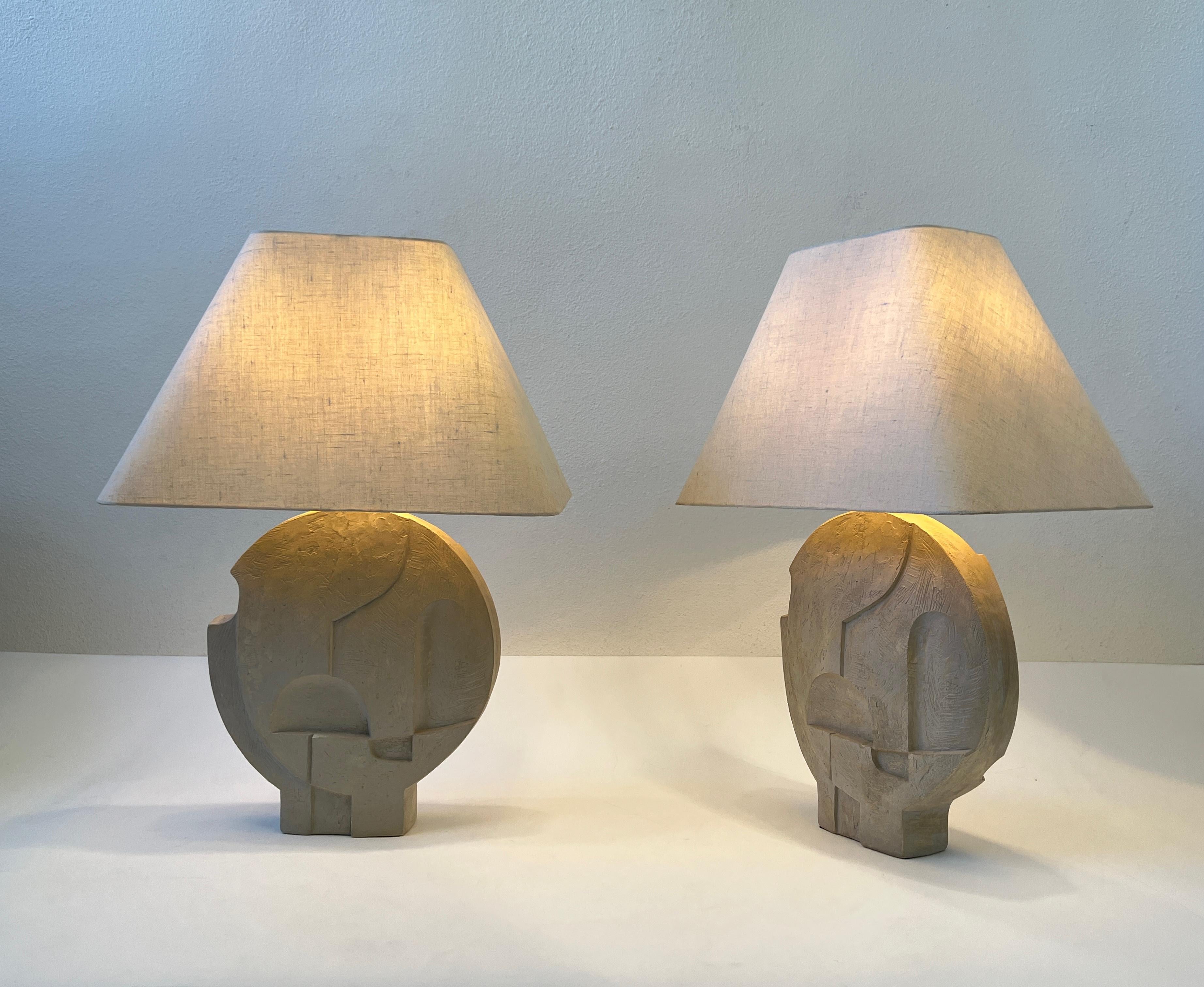 Glamorous pair of geometric brutalist cast plaster table Lamps by Casual lamps of California.
This came out of a Steve Chase Designed estate in Rancho Mirage CA. 
Newly rewired with new polish brass hardware, the shades are original they show