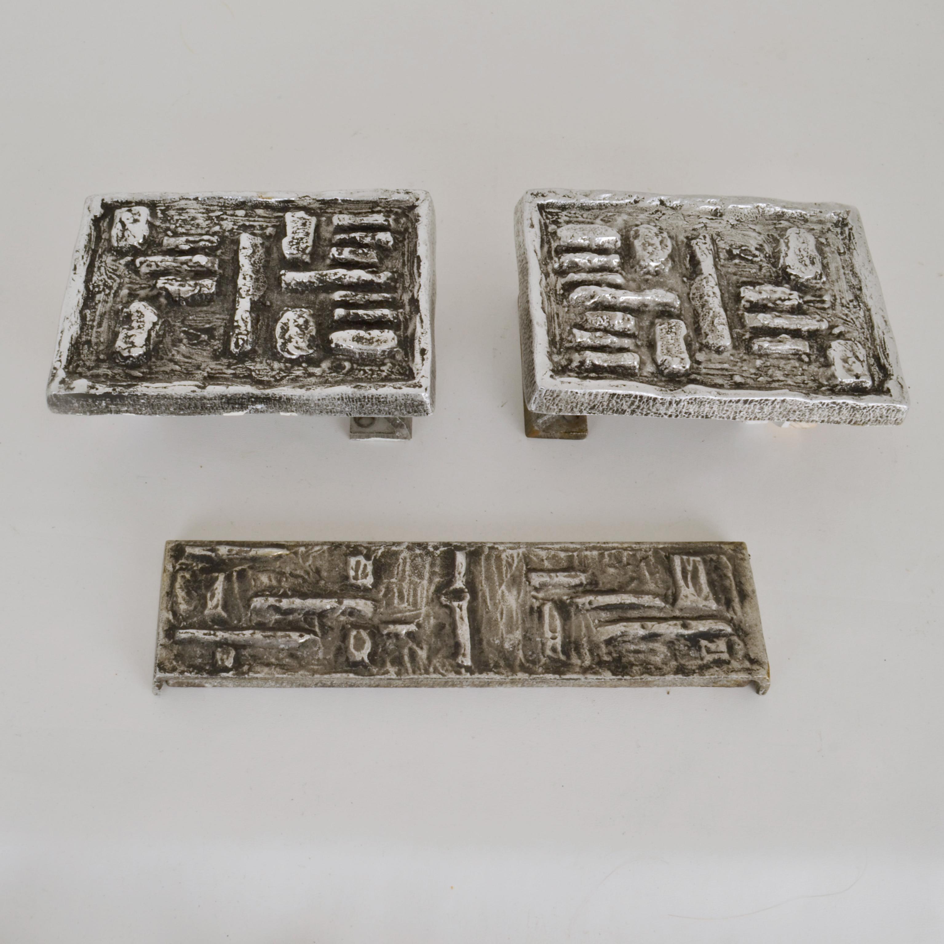 Pair of Brutalist rectangular push and pull door handles and letterbox with relief of angled squares and rectangles. Cast in aluminum with a polished texture to the top surface and nice patina in the deep areas. The design works on both exterior and
