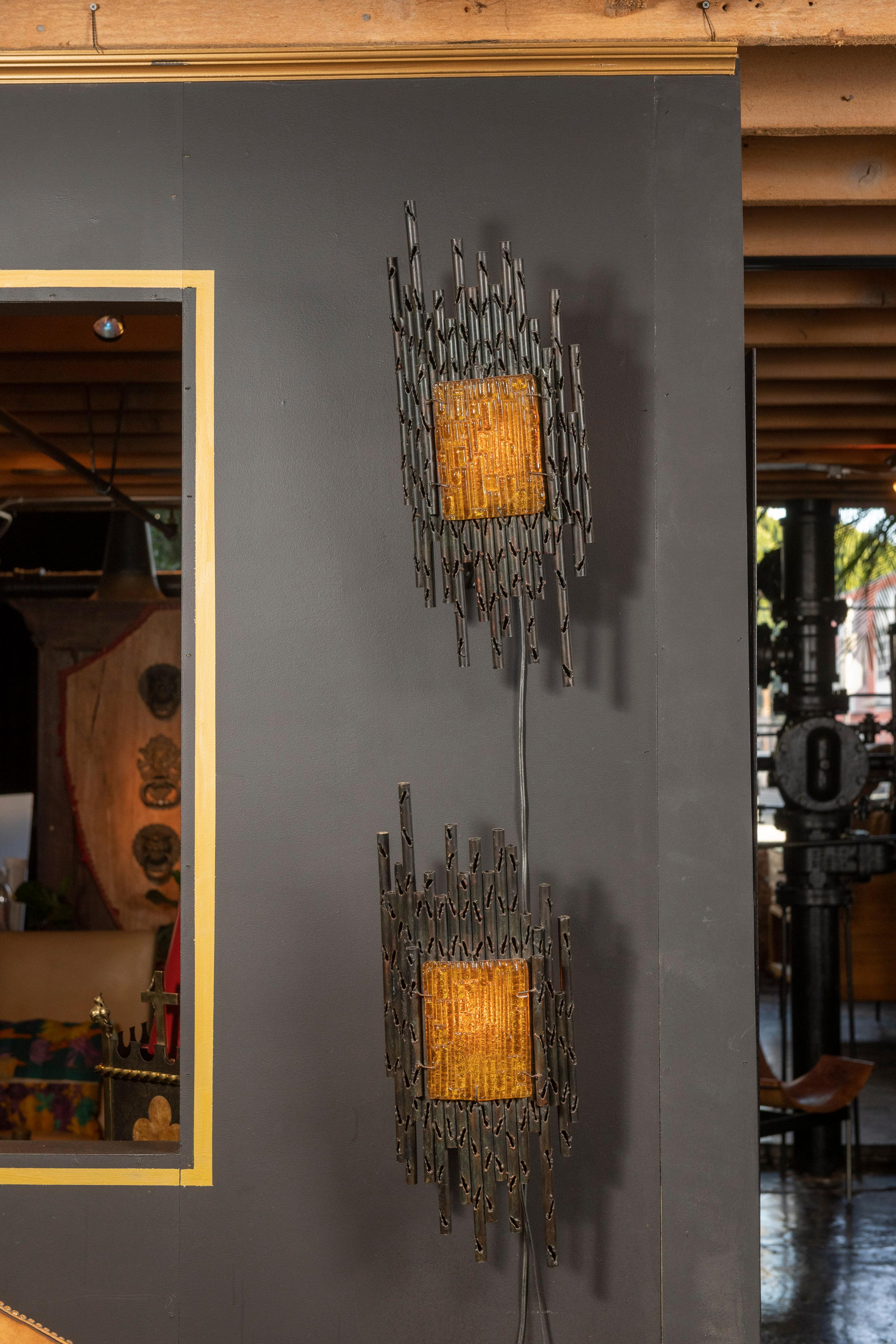
 
Pair of interesting brutalist sconces in the manner of Paul Evans, 20th Century.
Created from metal and resin, the sconces are perfect in many interiors, including arts & crafts, mission and modern. The pair are in very good condition with