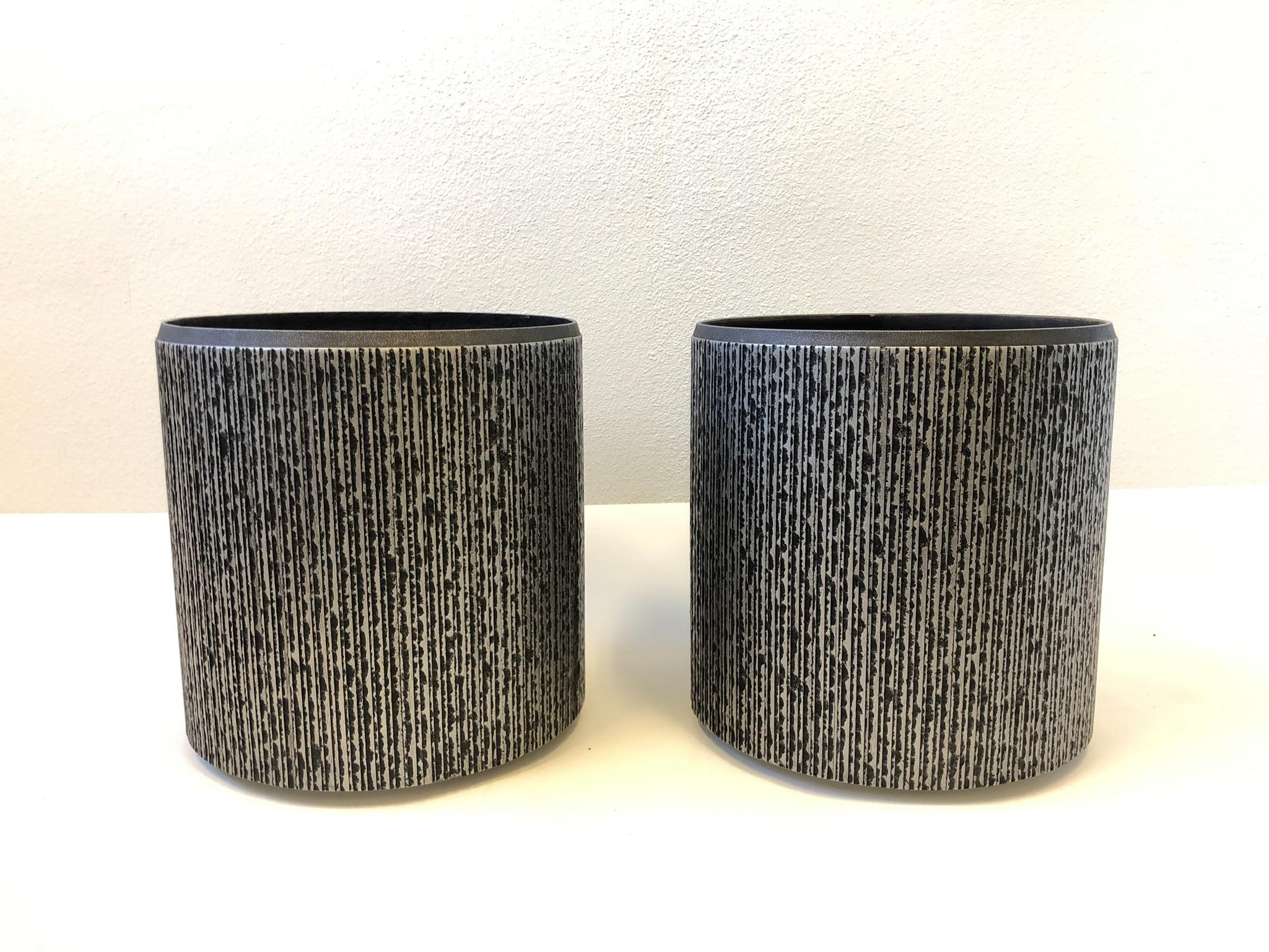 Brutalist pair of architectural planters designed by Forms and Surfaces for Steve Chase. 
The planters came out of a Steve Chase estate in Palm Desert CA. 
Constructed of fiberglass with a silver and black finish. 
Dimensions: 19.75” high and