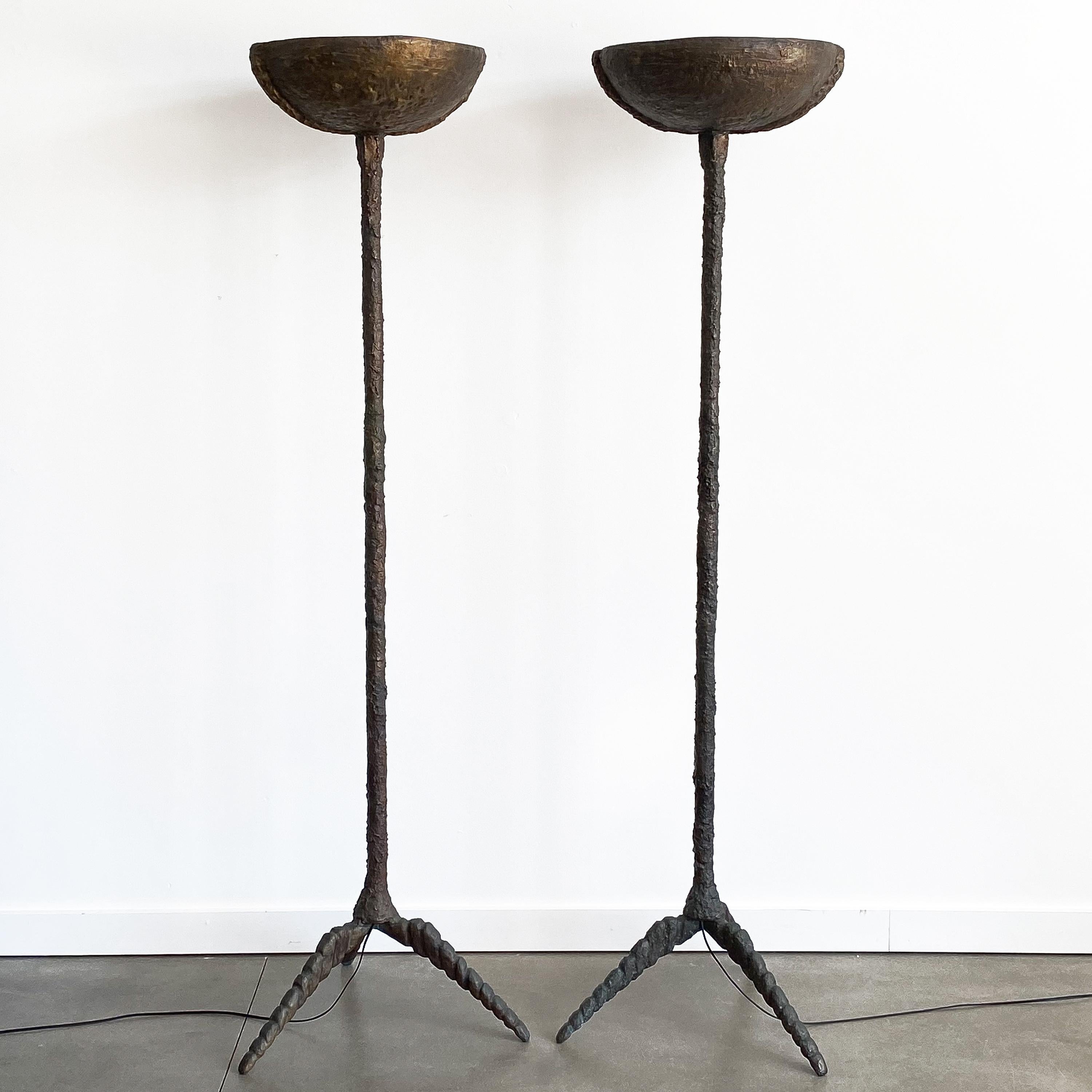 Pair of sculptural solid bronze torchère floor lamps with stylized tripod bases. Brutalist heavily textured hand cast and sculpted patinated solid bronze. Quite heavy and impressive in person! 18