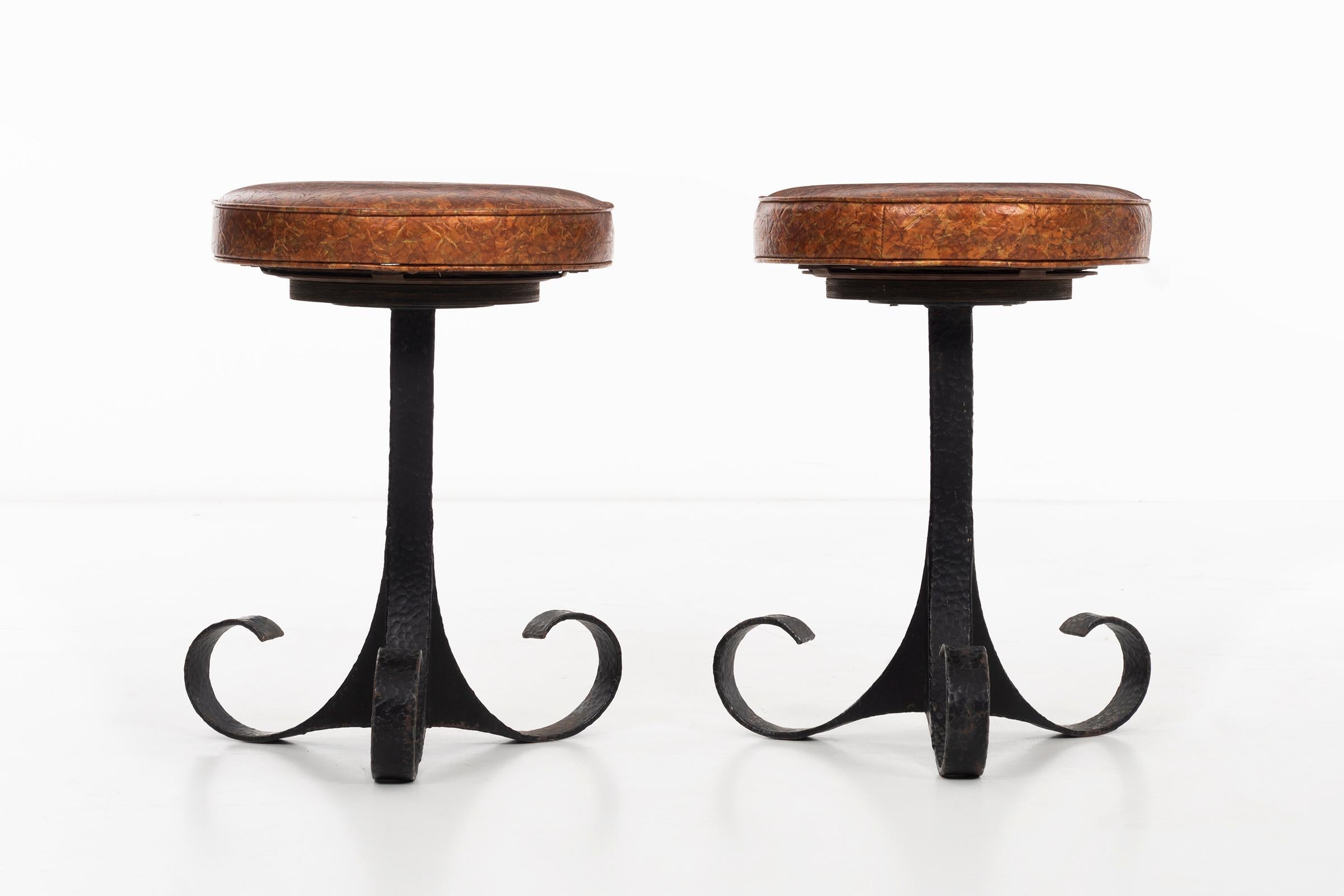 Hand-hammered swivel stools, scroll legs with original iridescent colored vinyl.