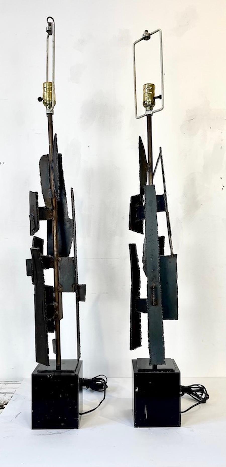 This striking pair of Brutalist table lamps by renowned designer Harry Balmer was crafted for Laurel Lamp Co. in 1963, Newark, New Jersey. Each lamp exemplifies Balmer’s signature Brutalist aesthetic with torch-cut and enameled steel, creating a