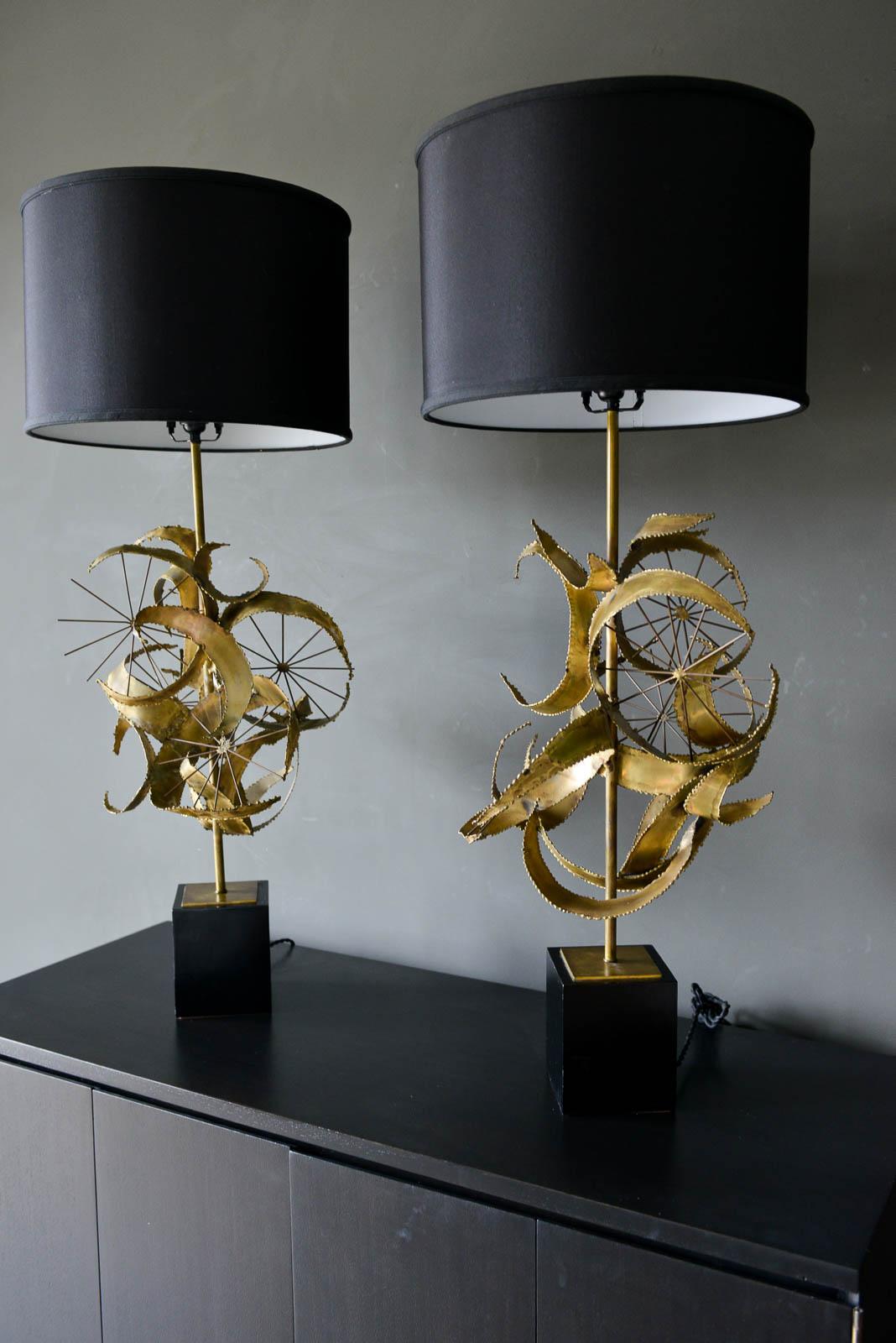 Pair of Brutalist torch cut metal lamps by Laurel Lamp Co., 1968. Beautiful pinwheel circle design with black bases and matching black shades. Gorgeous hard to find pair in very good original condition with original silk cord. Titled Setarrah Model
