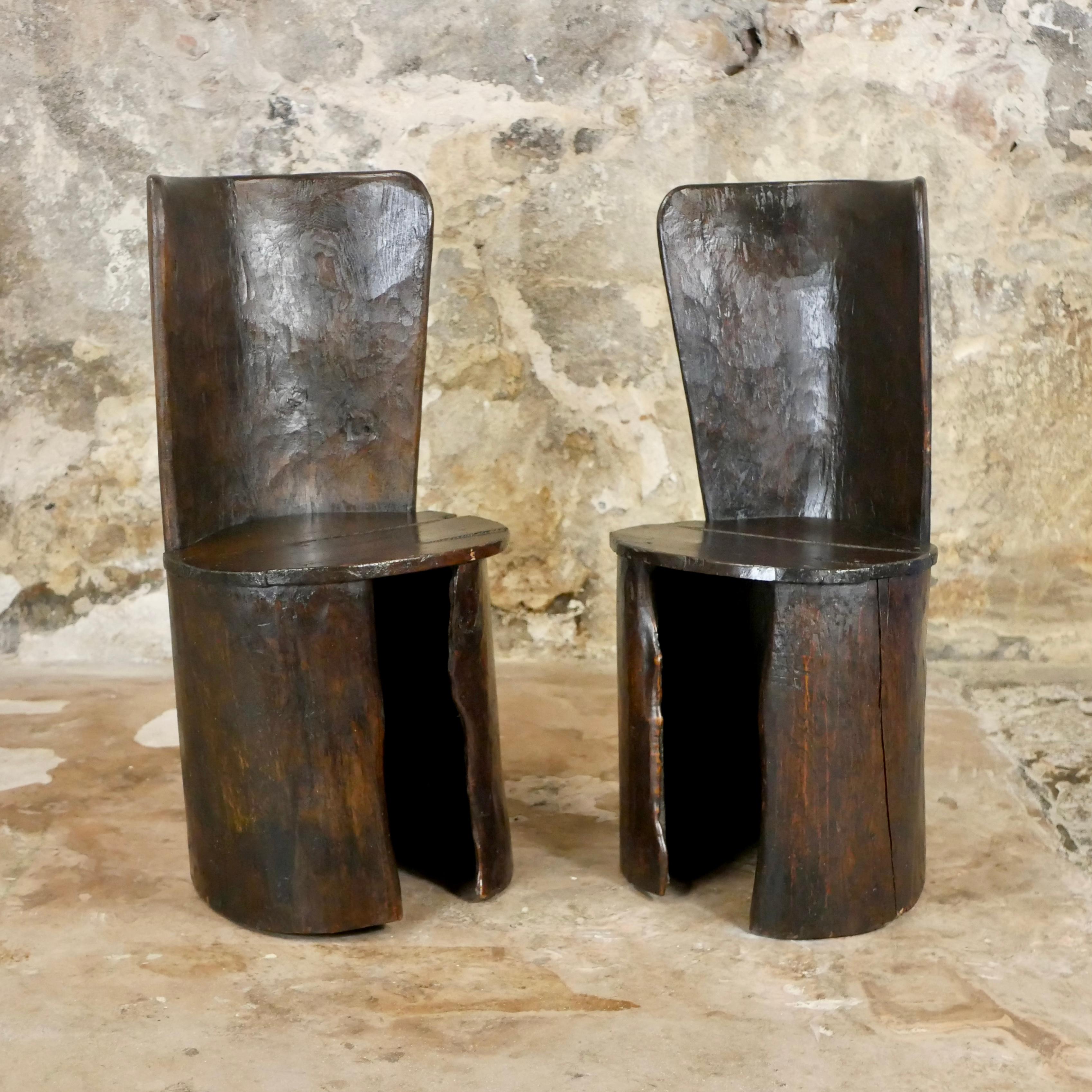 Stunning pair of trunk chairs, anonymous work from Finistère, Bretagne, in the far west of France. 
Made in the 1950s with local cherry trees.
Hand carved and assembled.
Very unique and adorable.
Beautiful wood grain and patina.
Traces of time : one