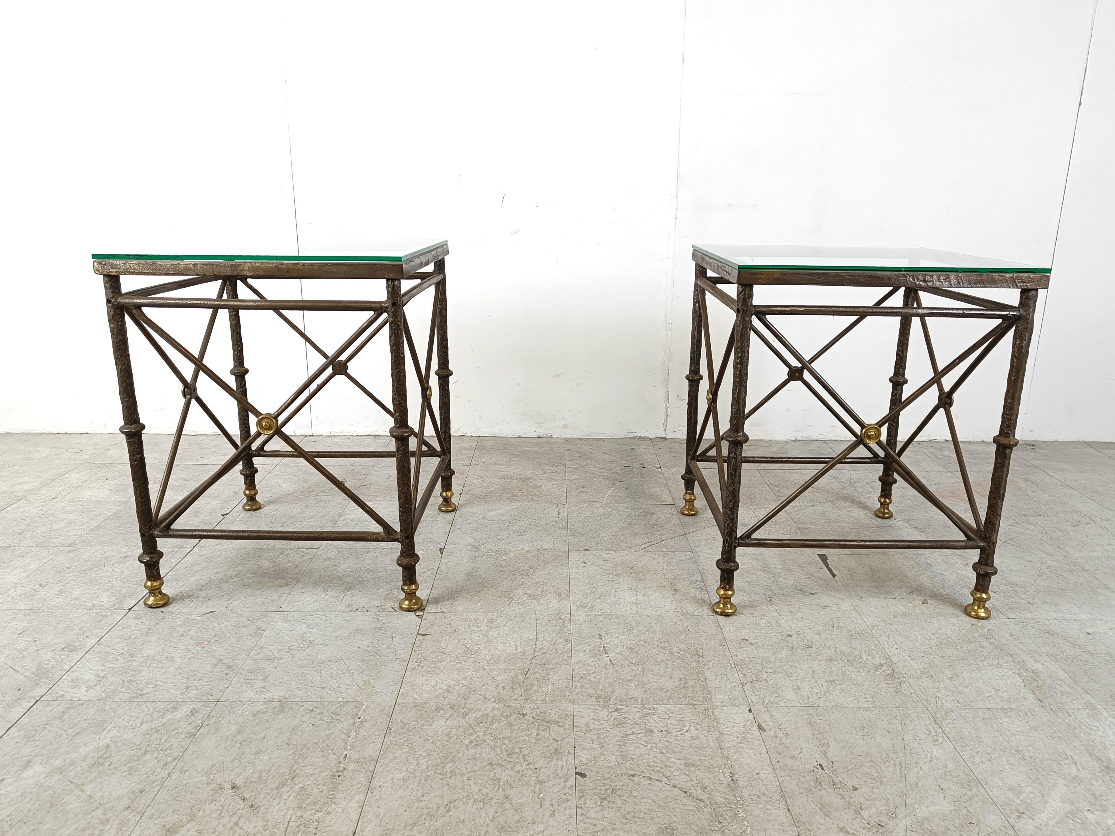 Pair of heavy wrought iron brutalist side tables with clear glass tops.

The frames are beautifully sculpted with brass feet and details.

They can be used as bases for a dining table or as side tables.

1970s - France

Height: 74cm/25.19