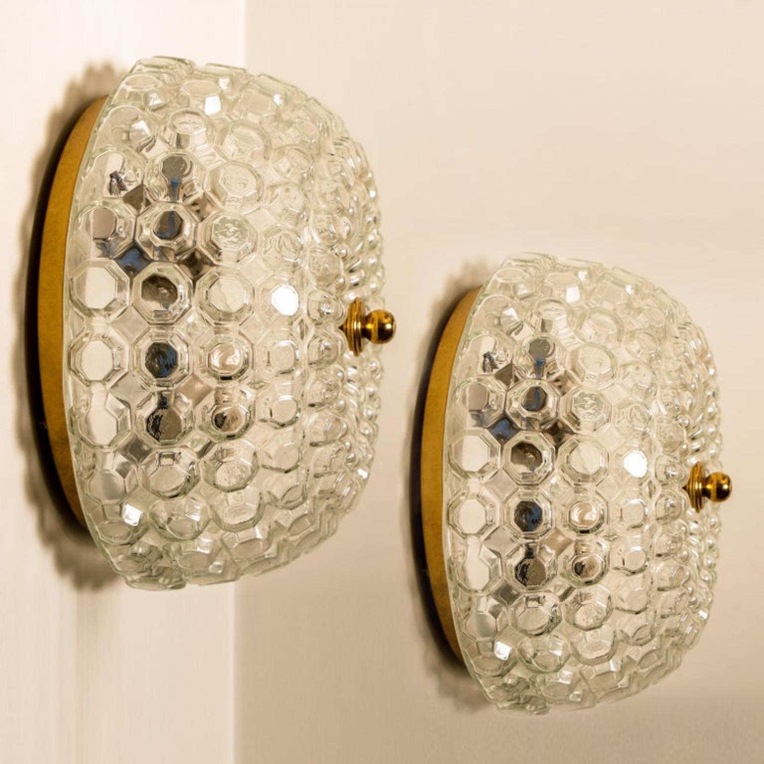Pair of  beautiful high-end large bubble flush mounts Helana Tynell for Limburg Glashütte, Germany, 1960s.
Made of glossy clear colored glass with a brass colored details and a white back plate. Illuminates beautifully.

Can work as impressive wall