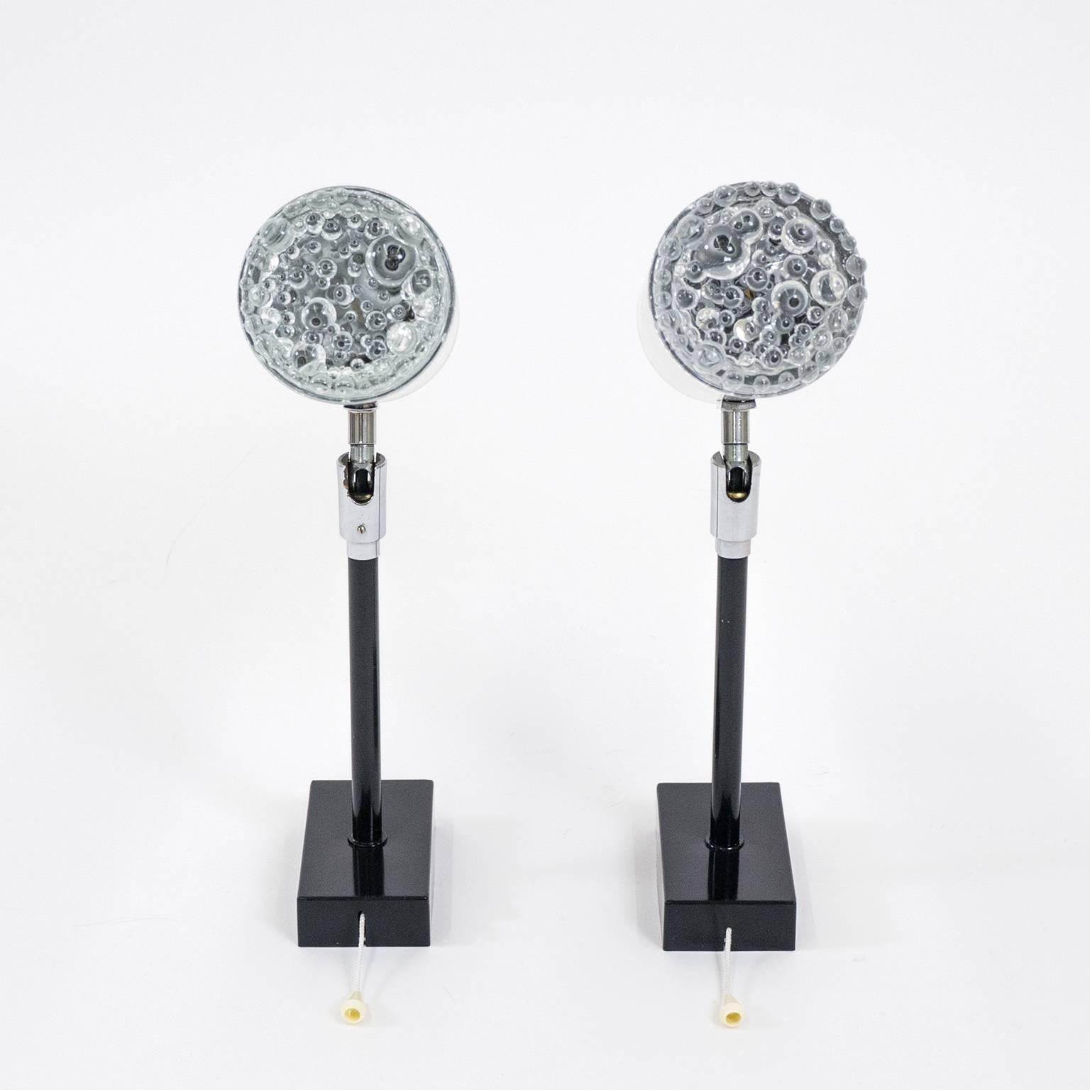 Stylish pair of large brushed aluminium and bubble glass wall lights (model W308) by Staff, 1970s. The large brushed aluminium body is attached to a black lacquered brass stem and can be rotated 360º and pivoted to hold virtually any position. Since