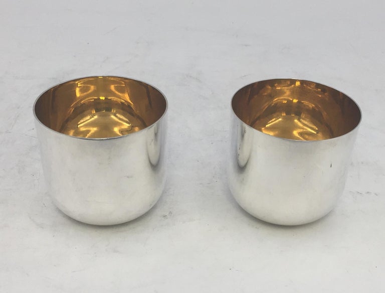 Rare pair of sterling silver cups by Buccellati with gilt interior in charming, geometric design. Measuring 2 3/4'' in height by 3'' in diameter and weighing 8.4 ozt. Bearing hallmarks as shown.

