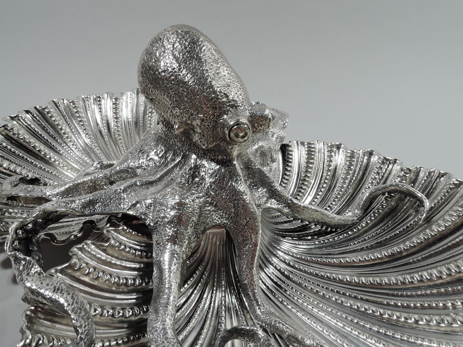 Pair of dramatic sterling silver seafood serving bowls. Made by Buccellati in Italy. Each: Two joined scallop-shells bowls on scallop-shell supports. A traditional form enlivened by the figure of an octopus squatting in the center, its curled and