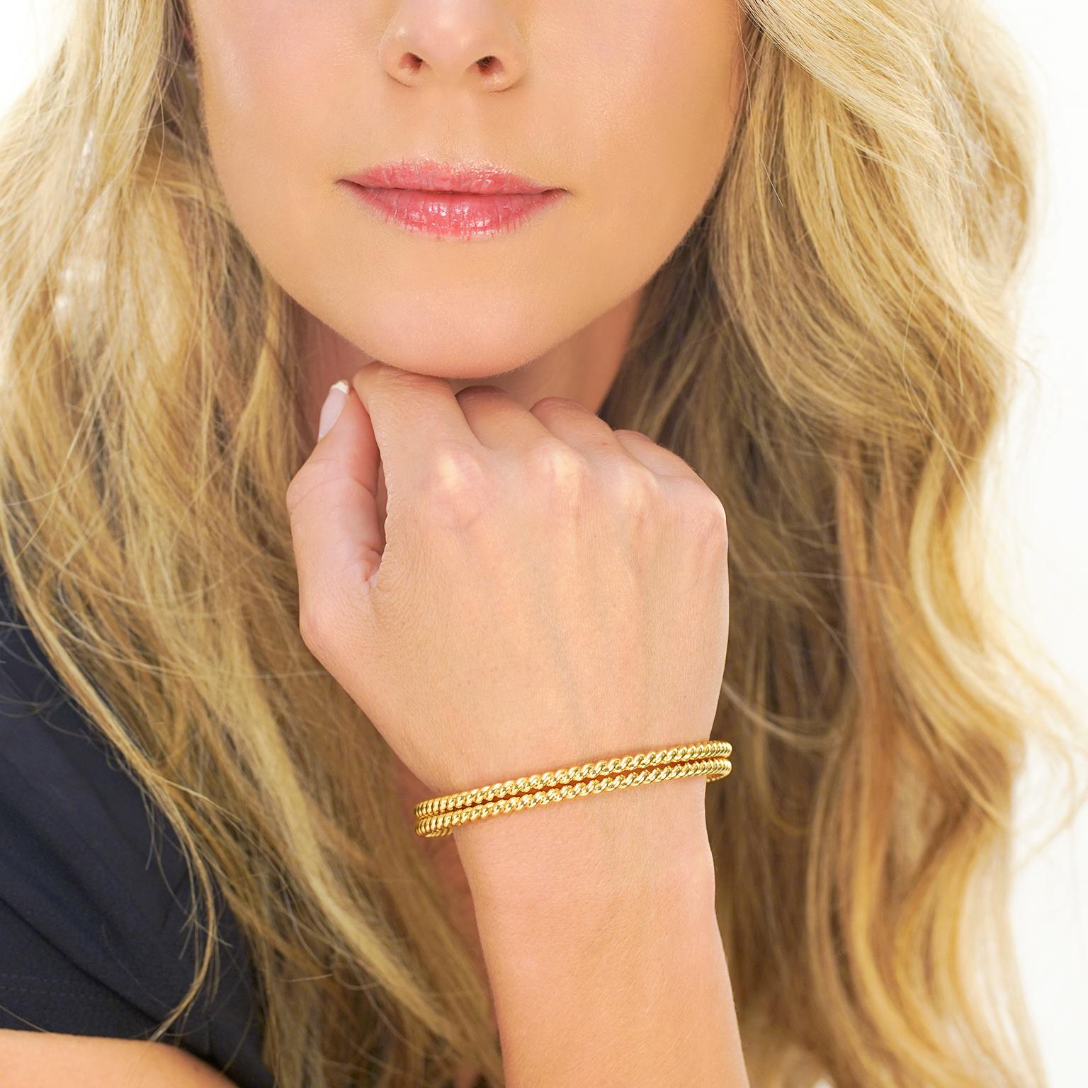 Circa 1980s, 18k, by Bucherer, Switzerland. This pair of timeless cable twist bracelets are effortlessly chic. Perfect on their own or mixed into a stack of other bangles, these eighteen-karat yellow gold bracelets are finely made to Bucherer's high