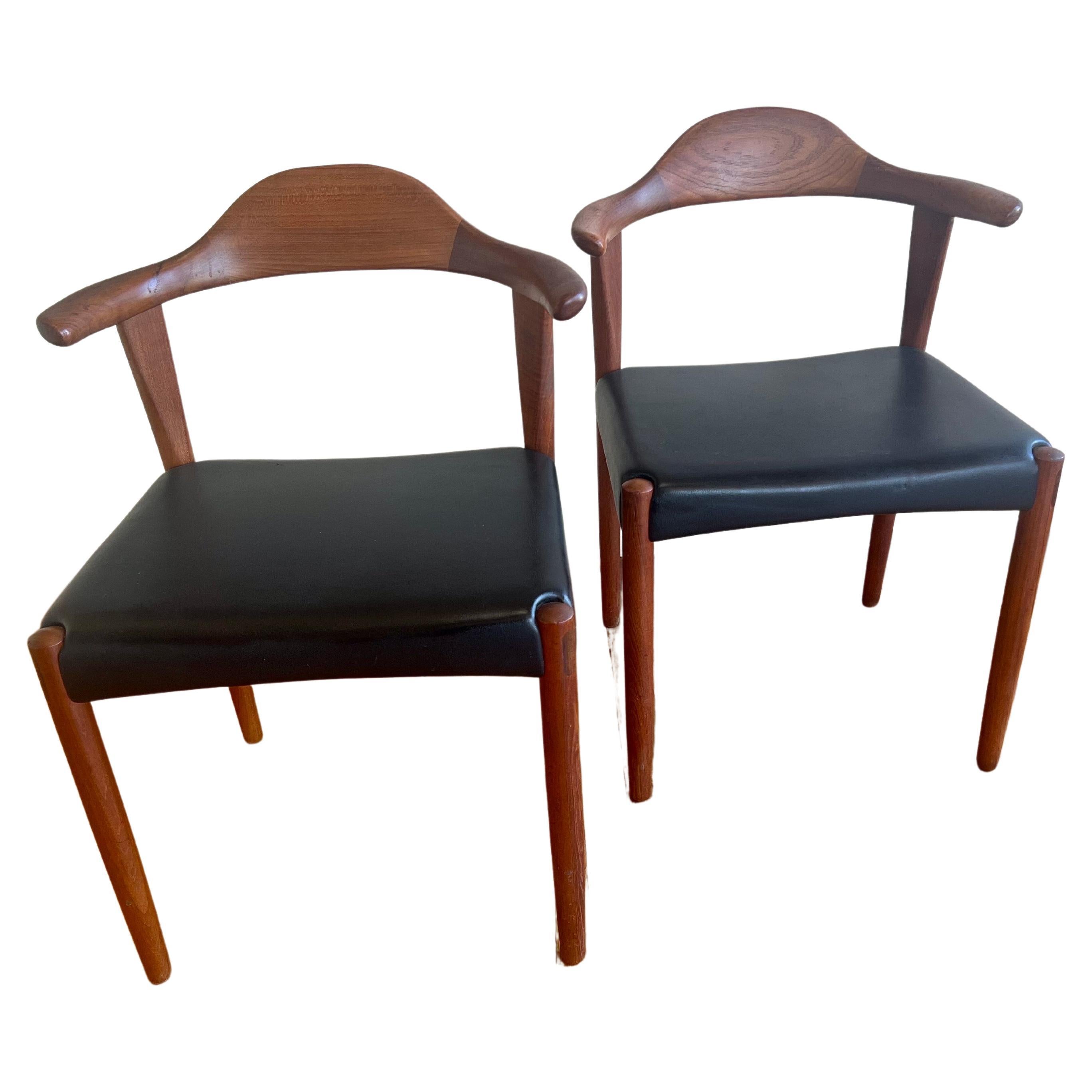 Immerse yourself in the timeless elegance of mid-century Danish design with this exquisite pair of 'Bull Horn' chairs crafted by Harry Østergaard for Randers Møbelfabrik in the 1950s. These chairs stand as a testament to the unparalleled