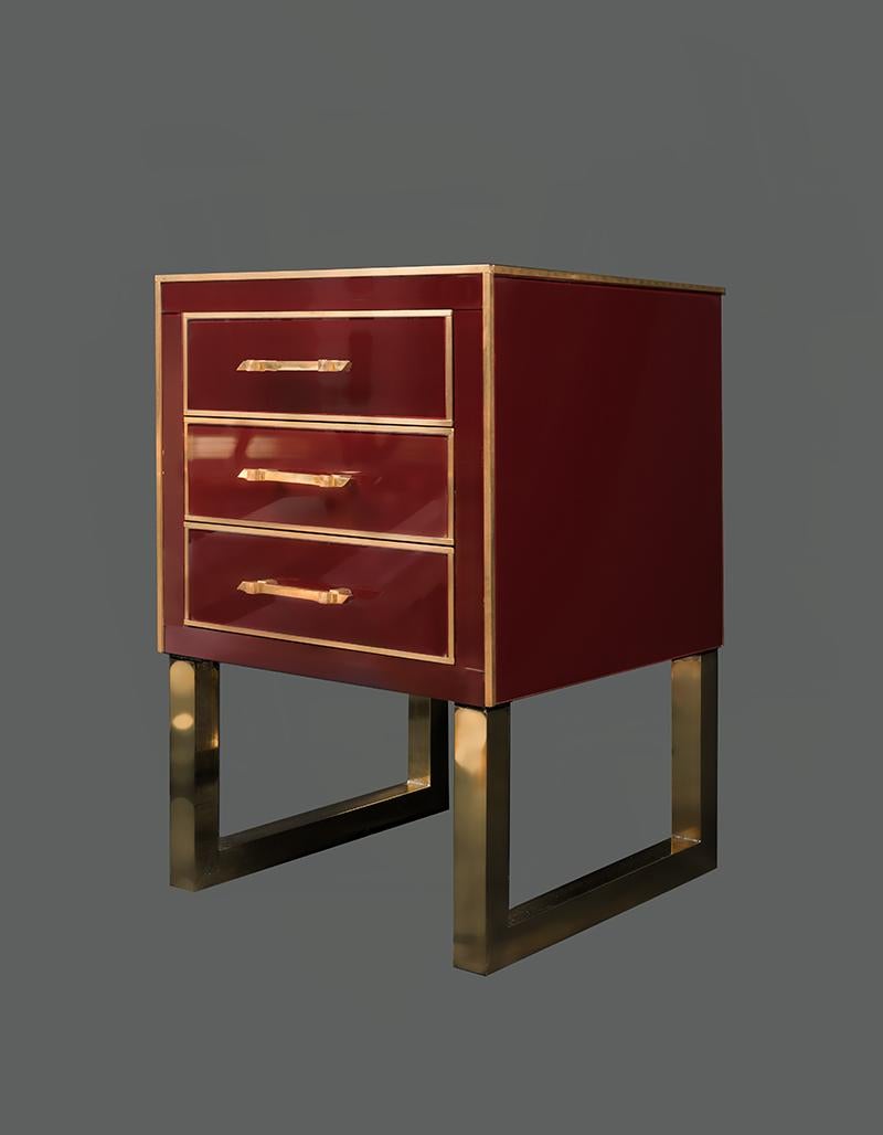 Pair of Burgundy opaline glass nightstands, brass legs and fittings, three drawers.
 