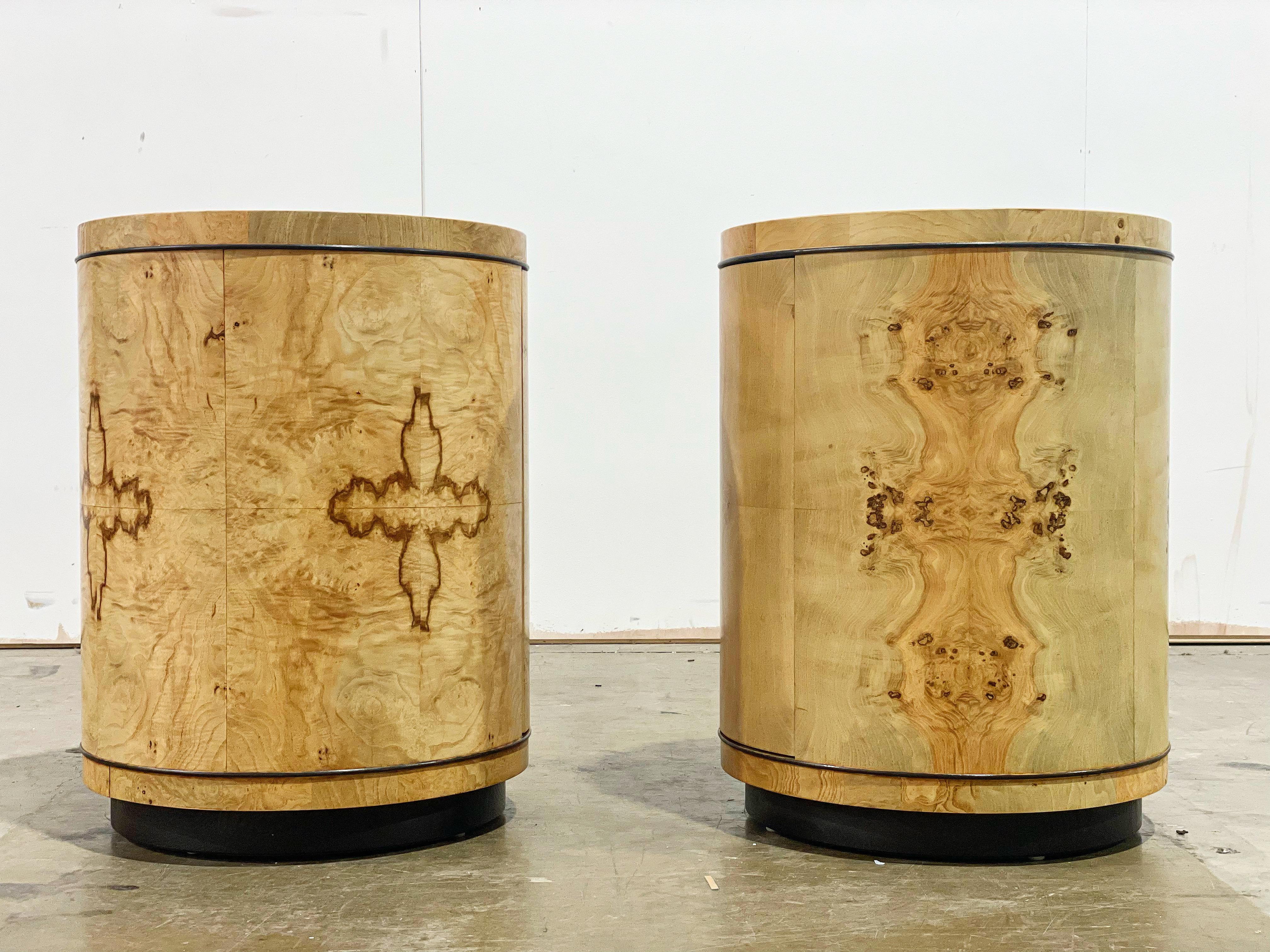 Exquisite pair of round drum tables in book matched burled olivewood with ebony trim detail and solid ash cabinets. A subtle design that commands attention. Produced circa 1980 by Henredon for their famed Scene Two line.
These look to have been