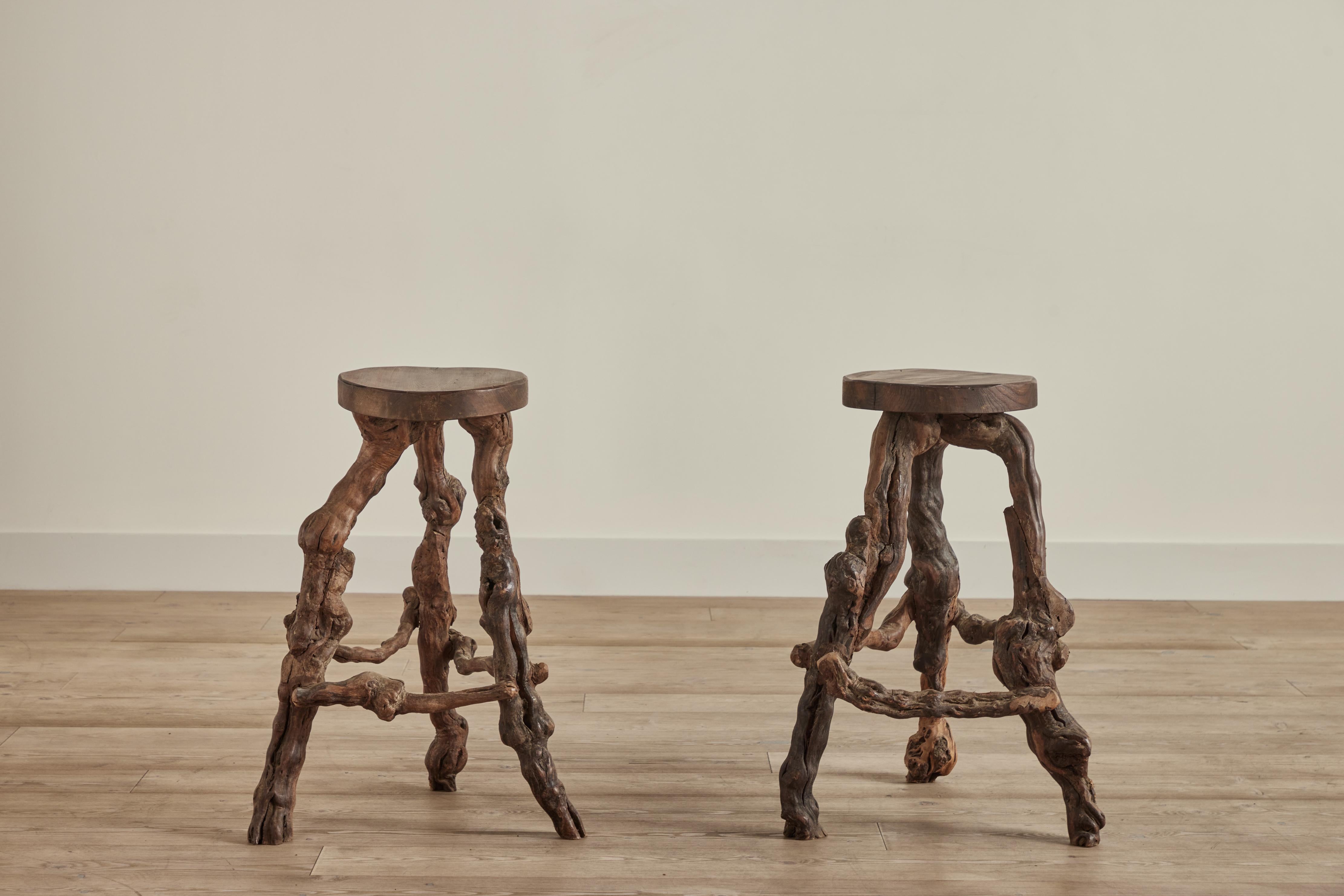 Pair of burled grapevine stools from France circa 1940. Wear on wood is consistent with age and use. Size of each stool varies slightly due to handmade nature. 