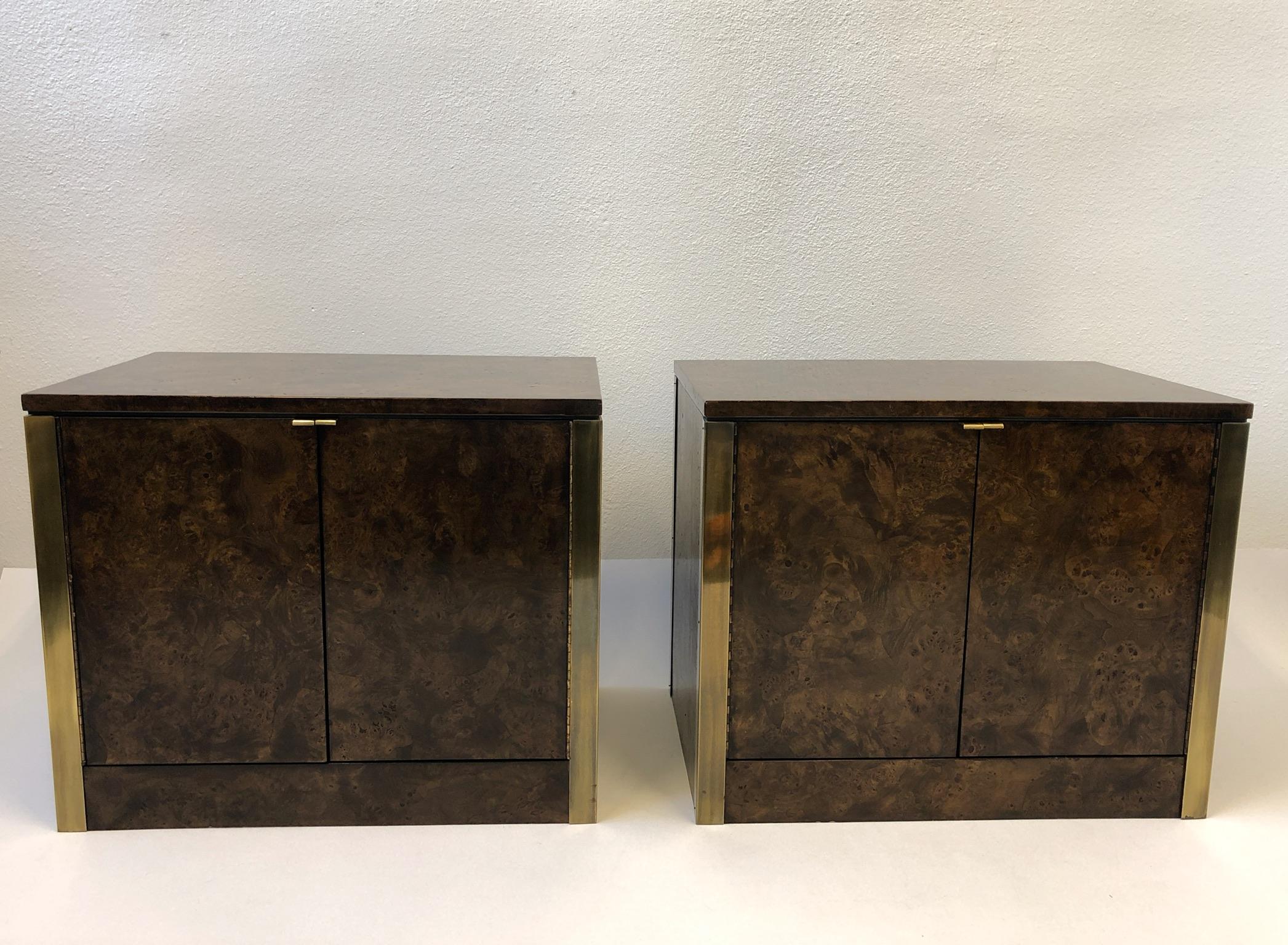 A spectacular pair of 1970s dark brown stain burl wood veneer and aged brass nightstands by Mastercraft. Each nightstand have an adjustable 10” deep shelf inside. This are in beautiful vintage condition. 

Dimensions: 28” wide 23” high 18” deep.