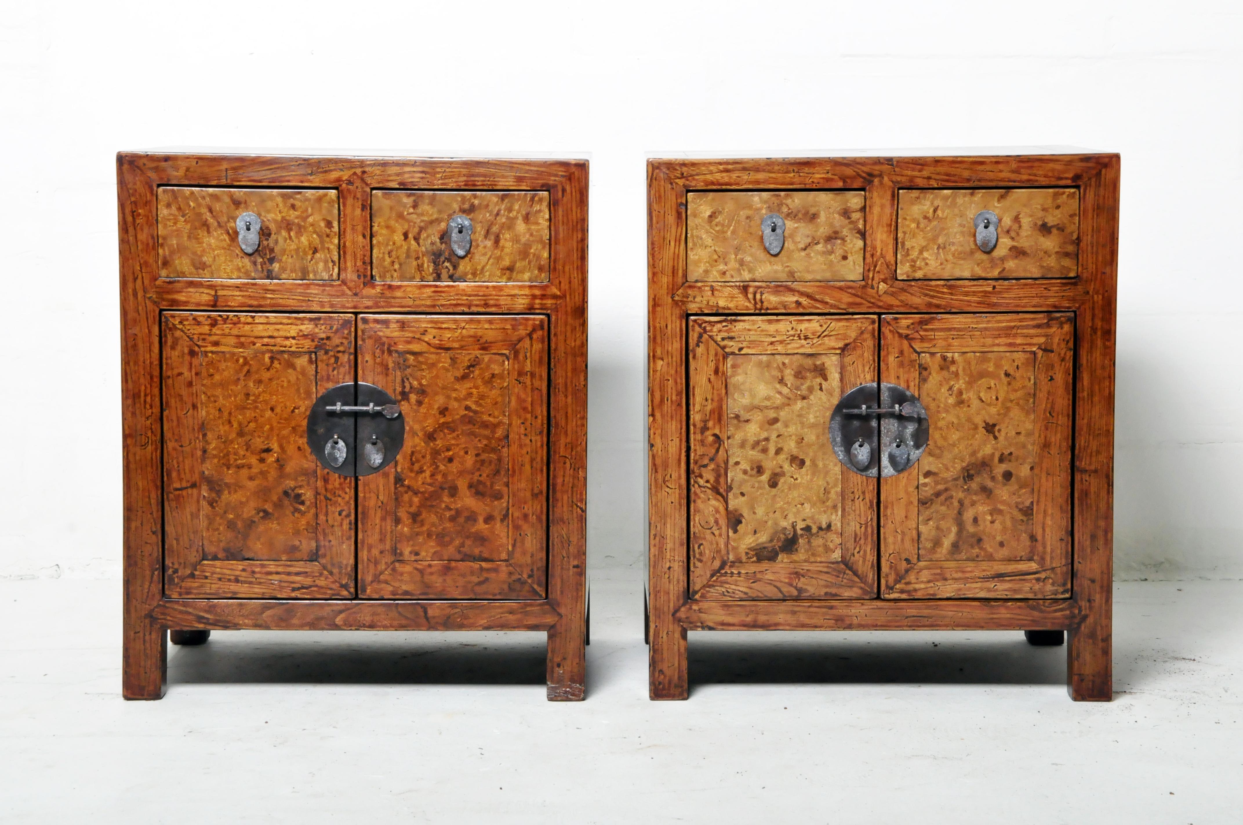 A restored pair of Chinese side chests. These chests are made from elmwood and have burlwood drawer fronts. The original oxblood lacquer was gently removed and the wood grain was revealed and protected by a layer of French polish (hand-rubbed