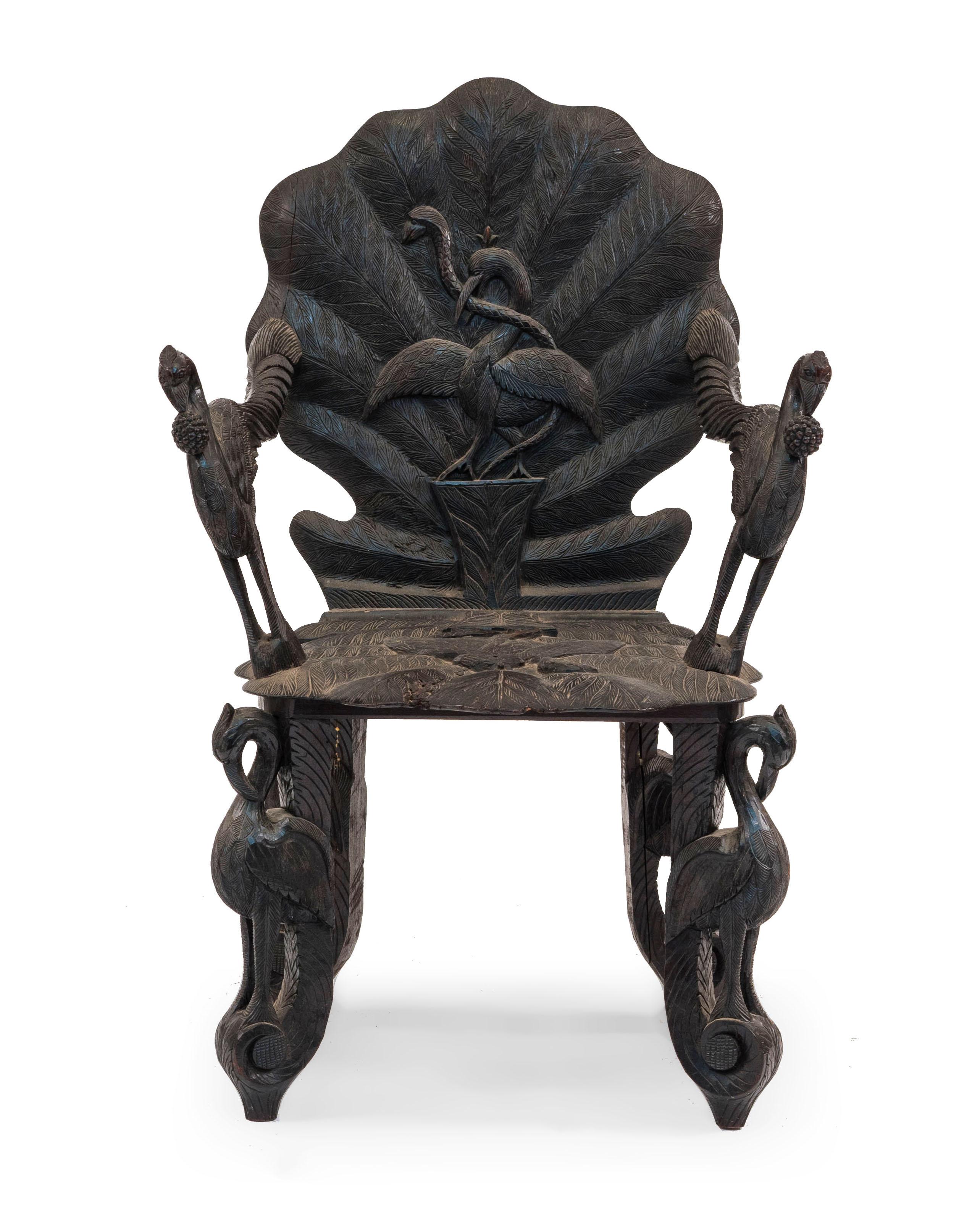 Pair of Asian Burmese style (19th century) ebonized carved arm chairs with leaf design seat and back with bird carved arms.