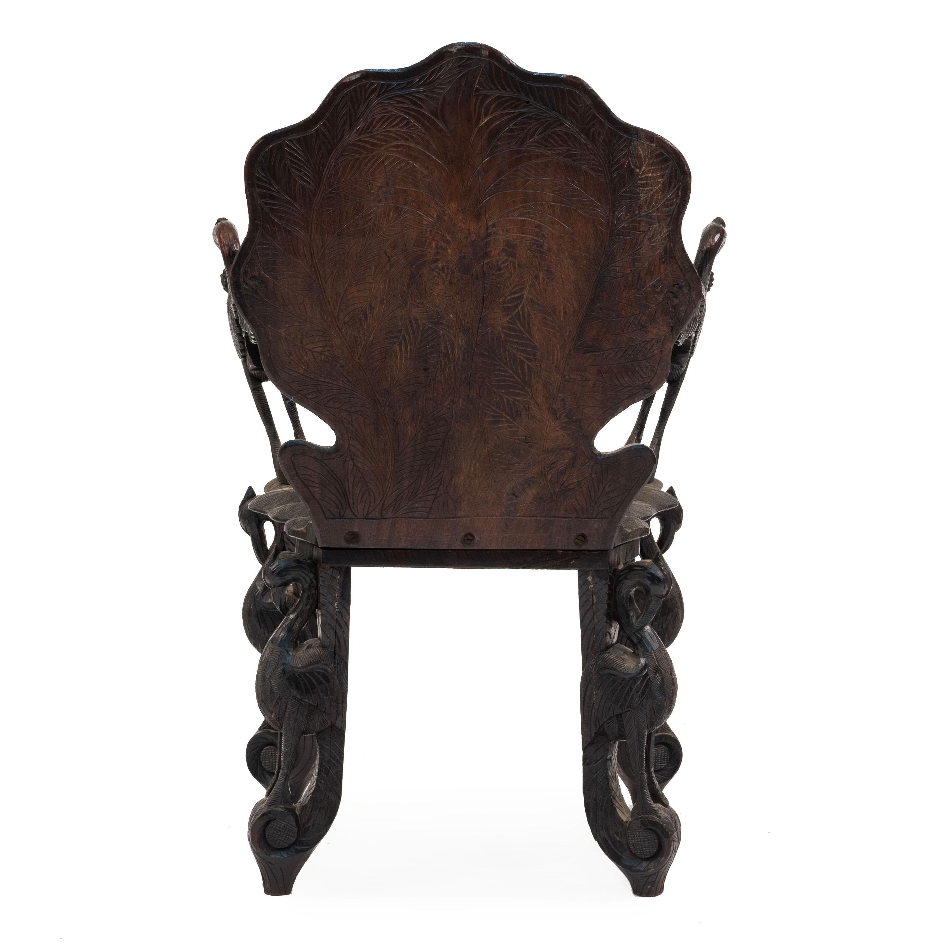 Wood Pair of Burmese Ebonized Carved Leaf and Bird Design Armchairs For Sale