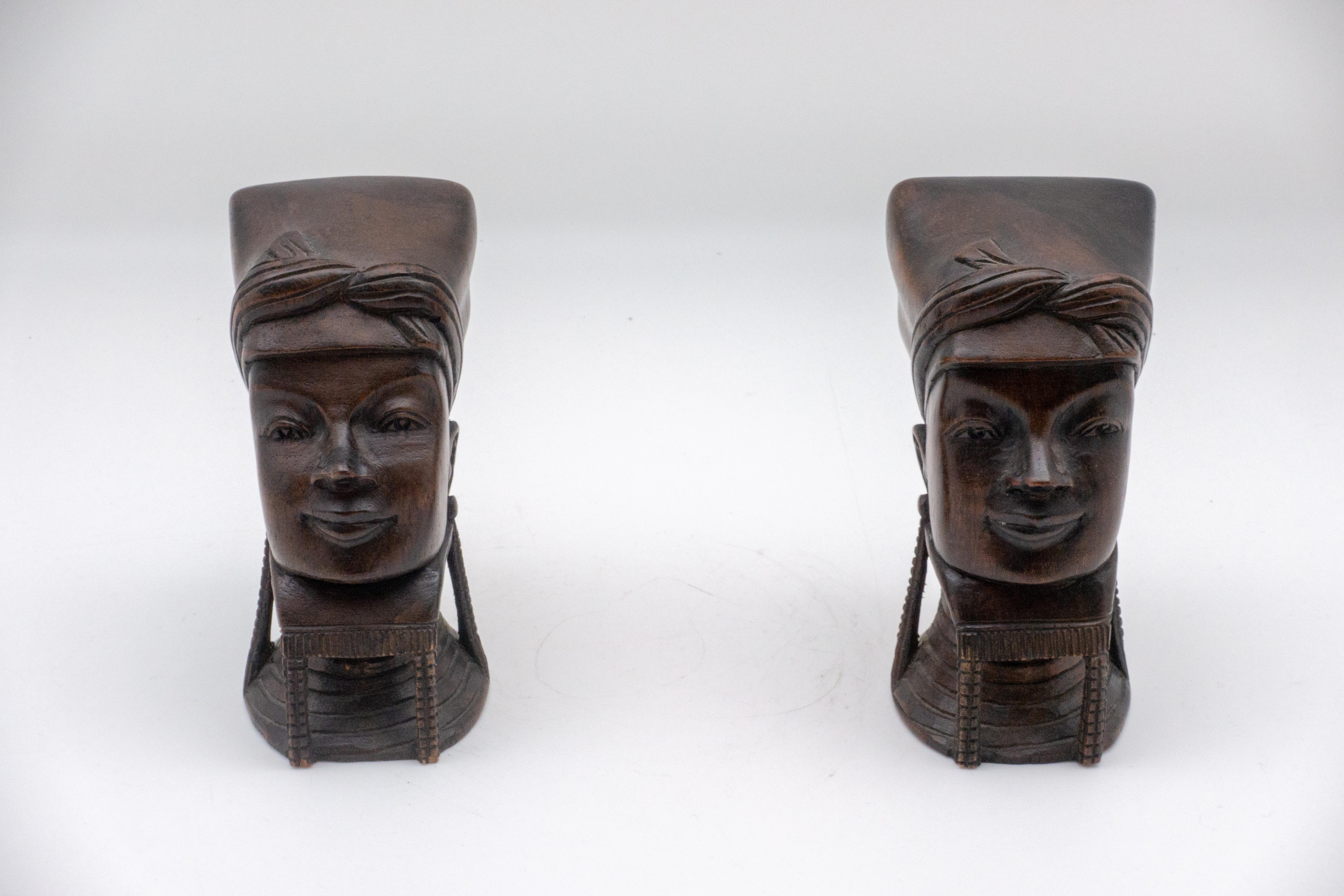 Wooden bookends/busts in the likeness of Myanma (Burmese) women, wearing traditional head covering and brass neck coils.
