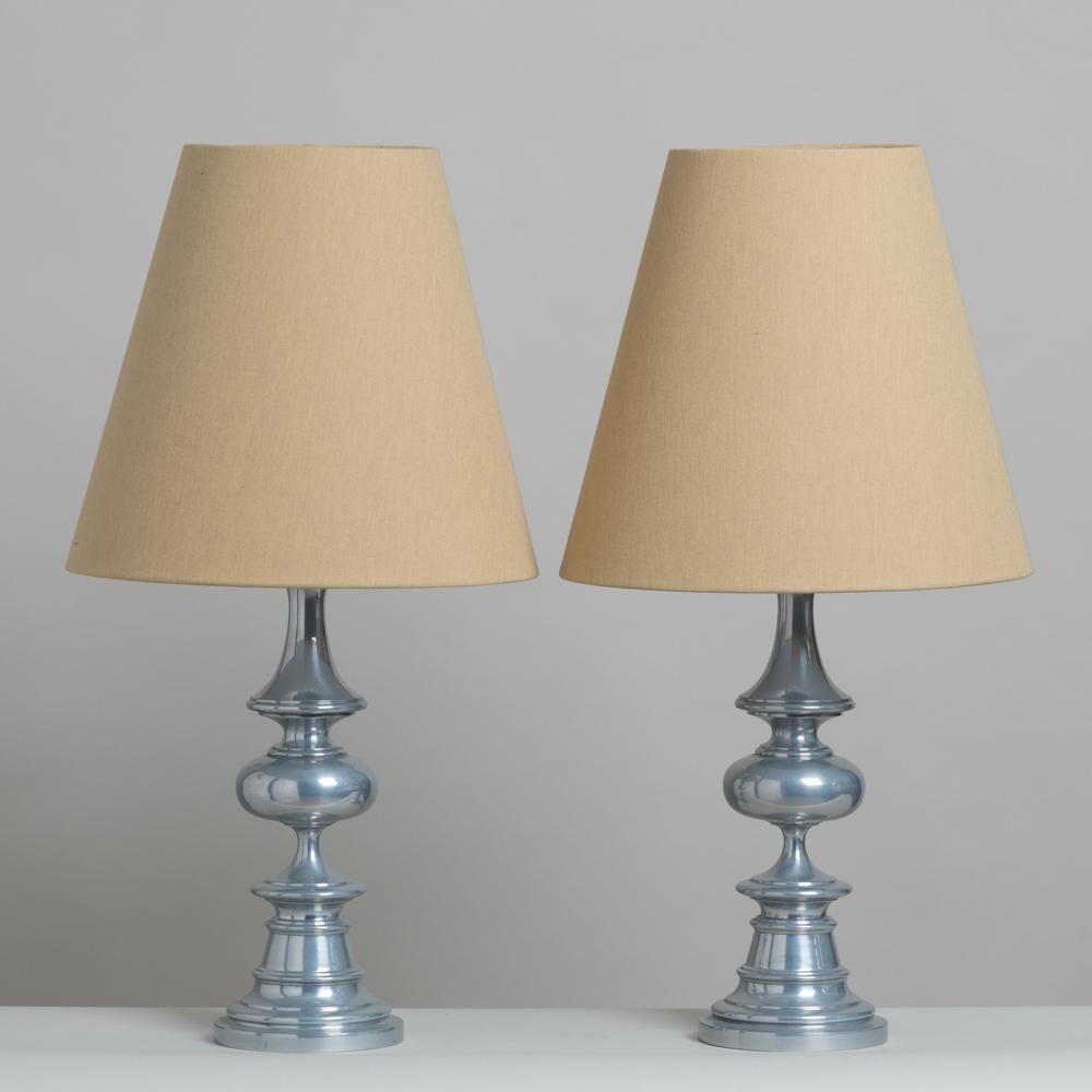 Pair of burnished aluminium table lamps accompanied with our fabric shades, 1960s.

Width is of the base of the lamp
