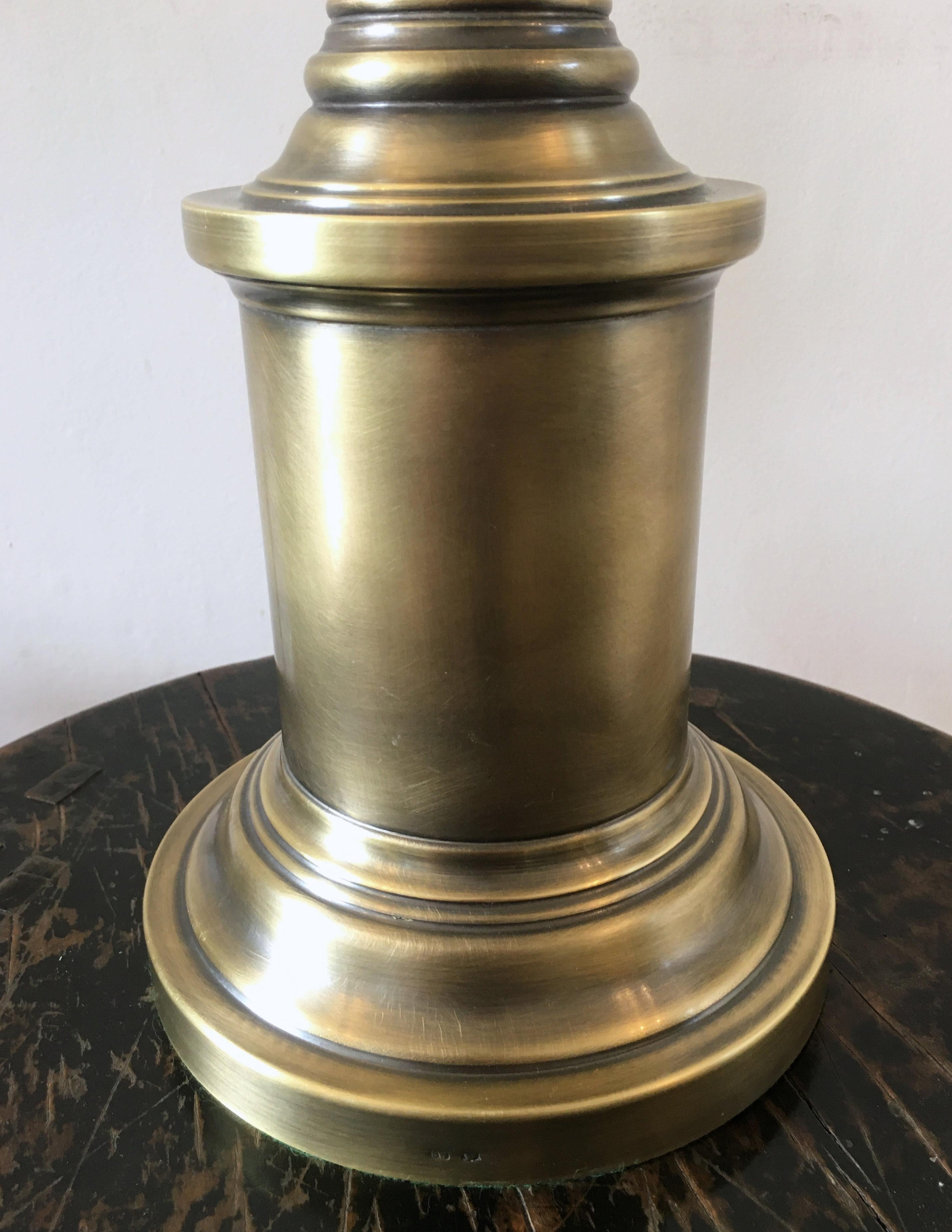 These sleek and elegant burnished brass table lamps have a slender column design with bayonet fittings. Each light measures 6 in - 15 cm diameter on the base with a height of 25 in - 63.5 cm. The pair would make a very stylish lighting feature for a