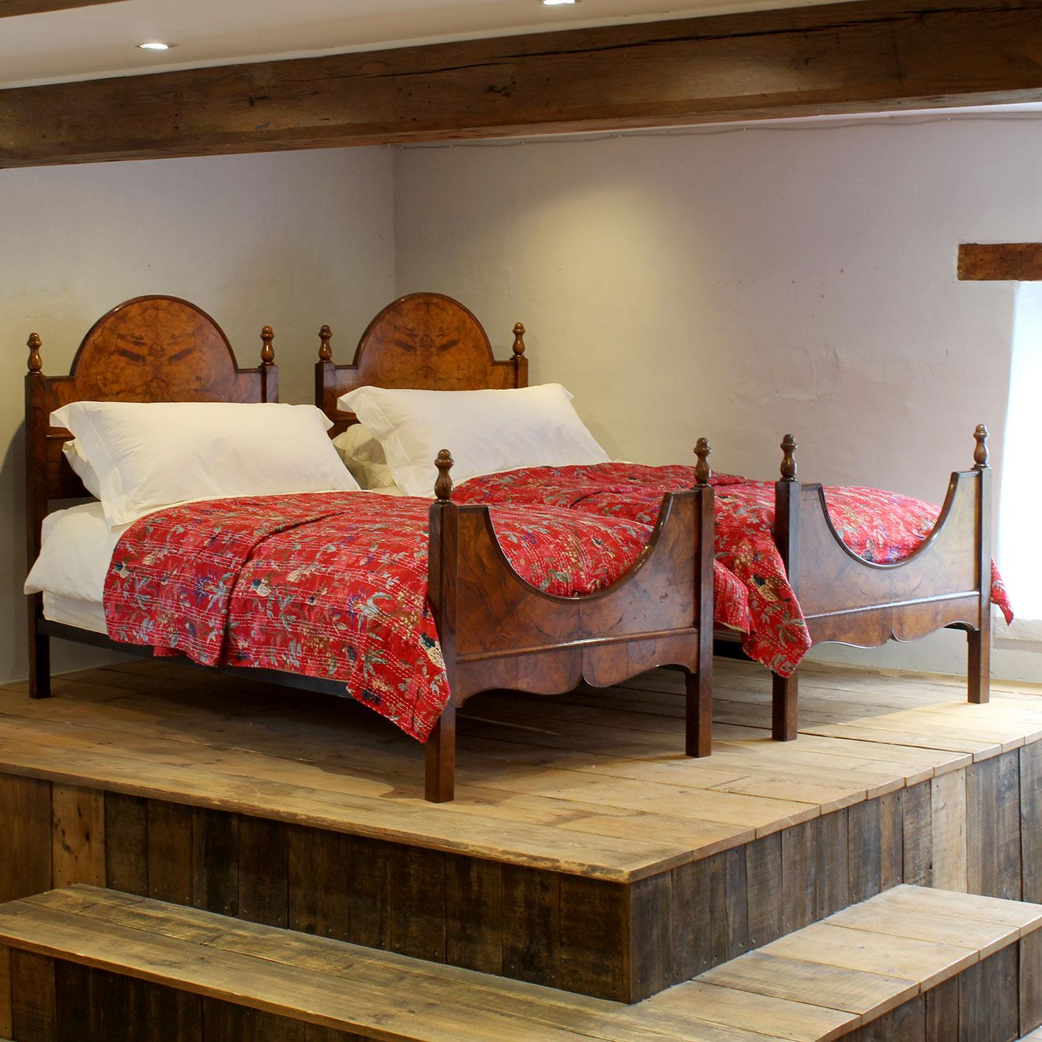 A fine matching pair of antique single beds in burr mahogany.
The beds accept wide single size bases and mattresses, 3ft wide (36 inches)
The price includes two standard firm bed bases to support the mattresses. 
The mattresses and bedding are extra