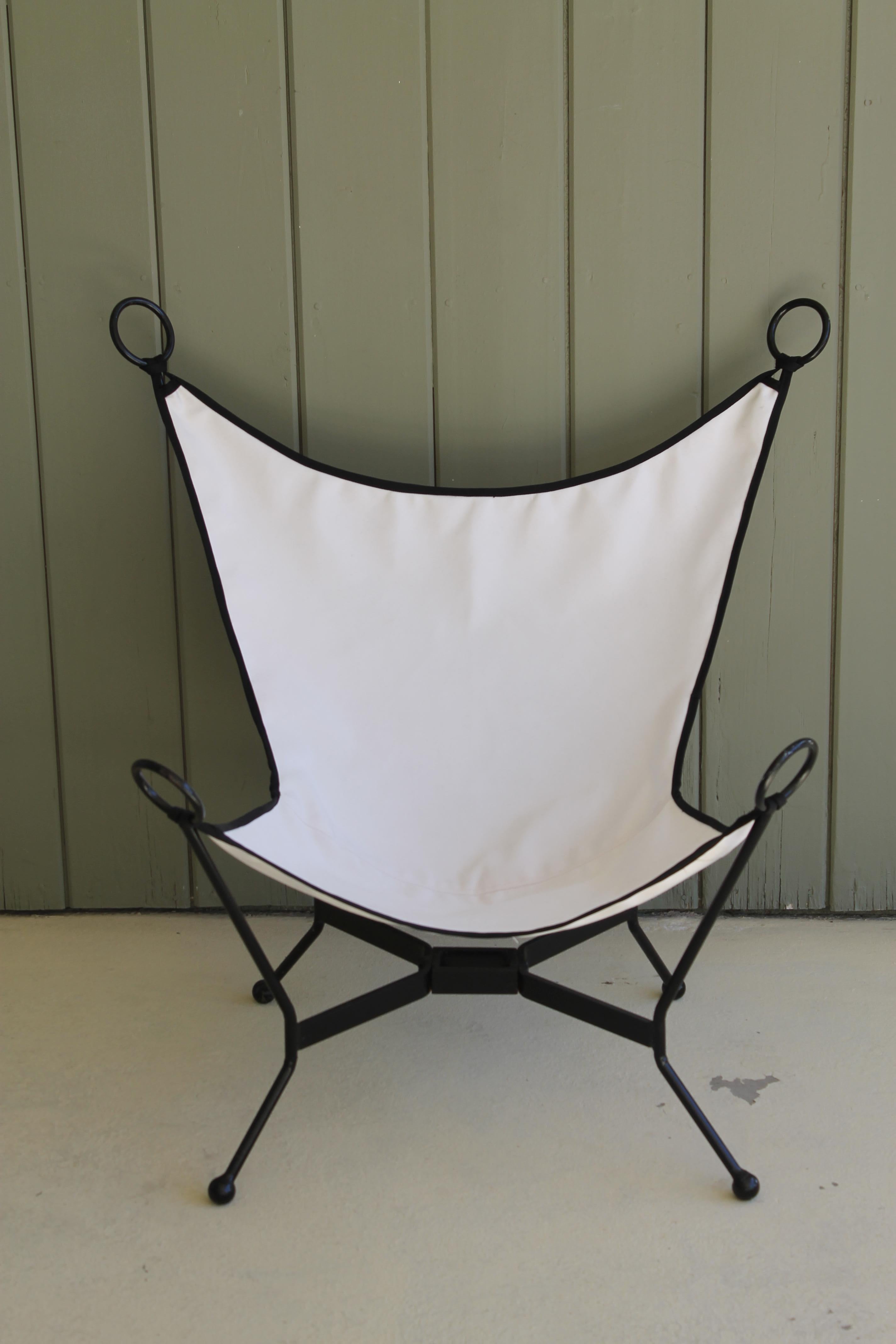Pair of sling patio chairs. We had them powder coated a satin black and upholstered in sunbrella fabric. One chair is slightly smaller (or larger) then the other. The large chair is 36” wide, 32” deep and 35” high. Seat height is 12.5”. The small