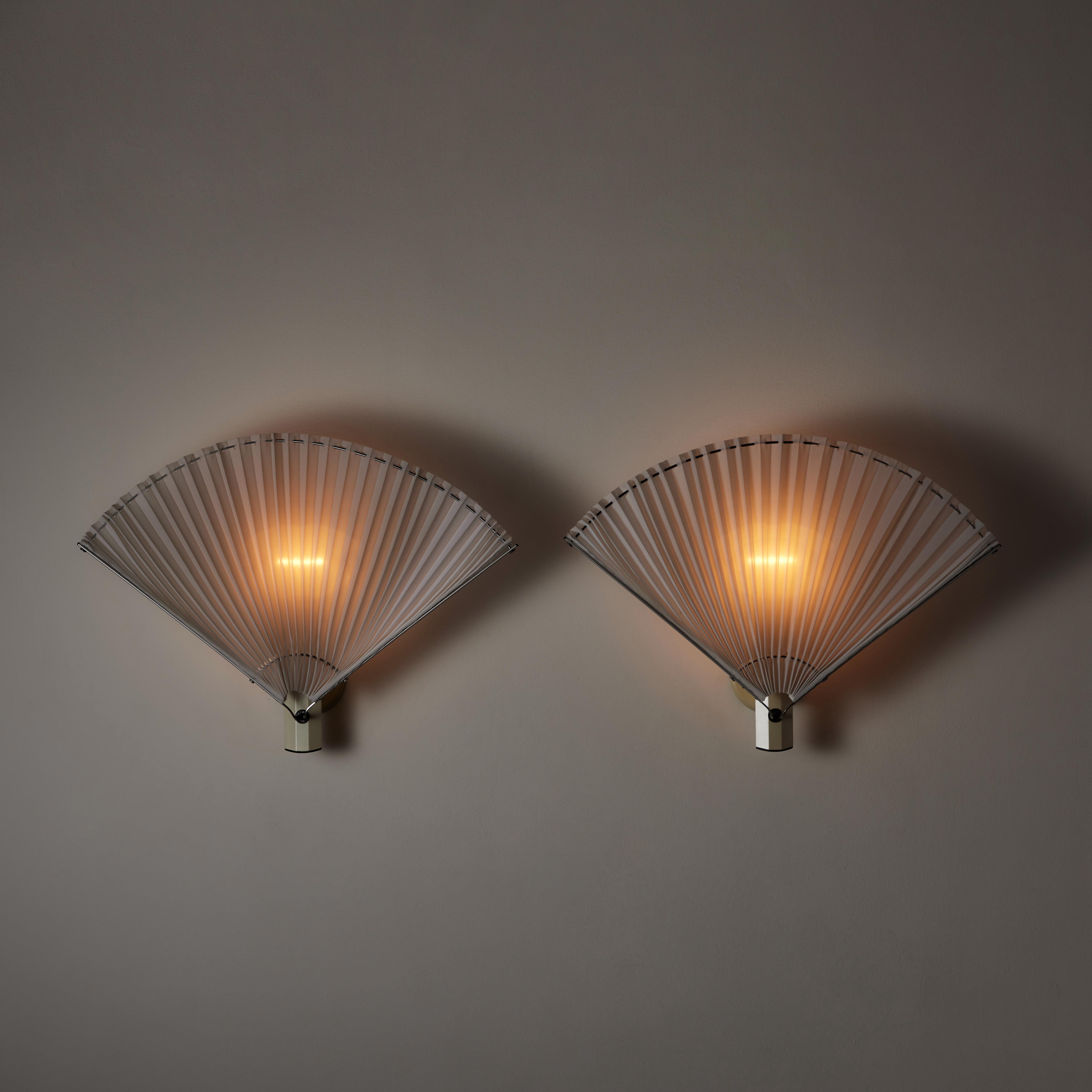 Pair of ‘Butterfly’ sconces by Afra and Tobia Scarpa for Flos. Designed and manufactured in Italy, circa the 1980s. Cast Iron, metal, fabric, textured glass diffuser. Rewired for U.S. standards. Retains original manufacturer's stamp. We recommend