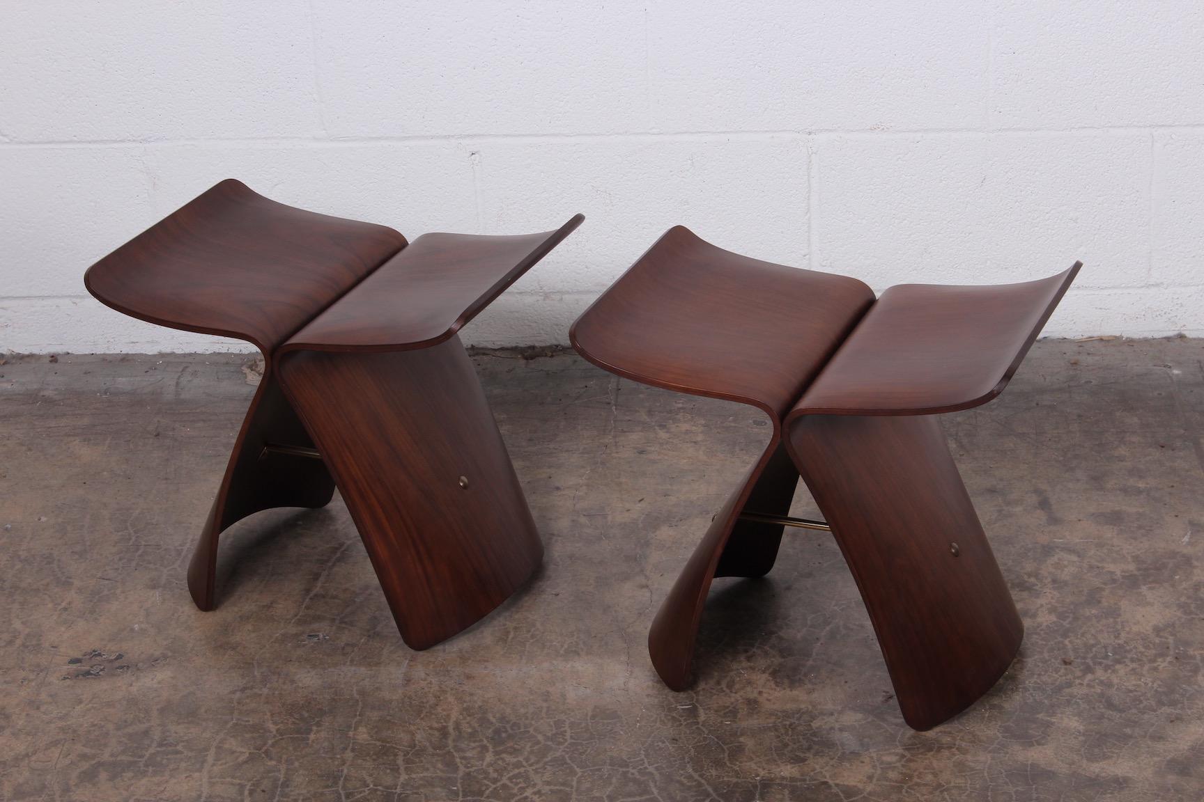 A pair of rosewood butterfly stools designed by Sori Yanagi.