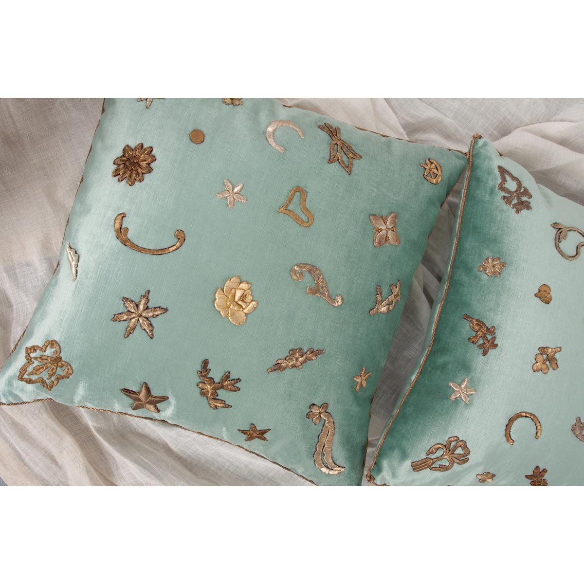 These pop art design pillows have antique raised gold and silver, upcycled metallic embroidery in a random pattern on aqua velvet. Hand trimmed with vintage gold metallic cording, knotted in the corners. Down filled.