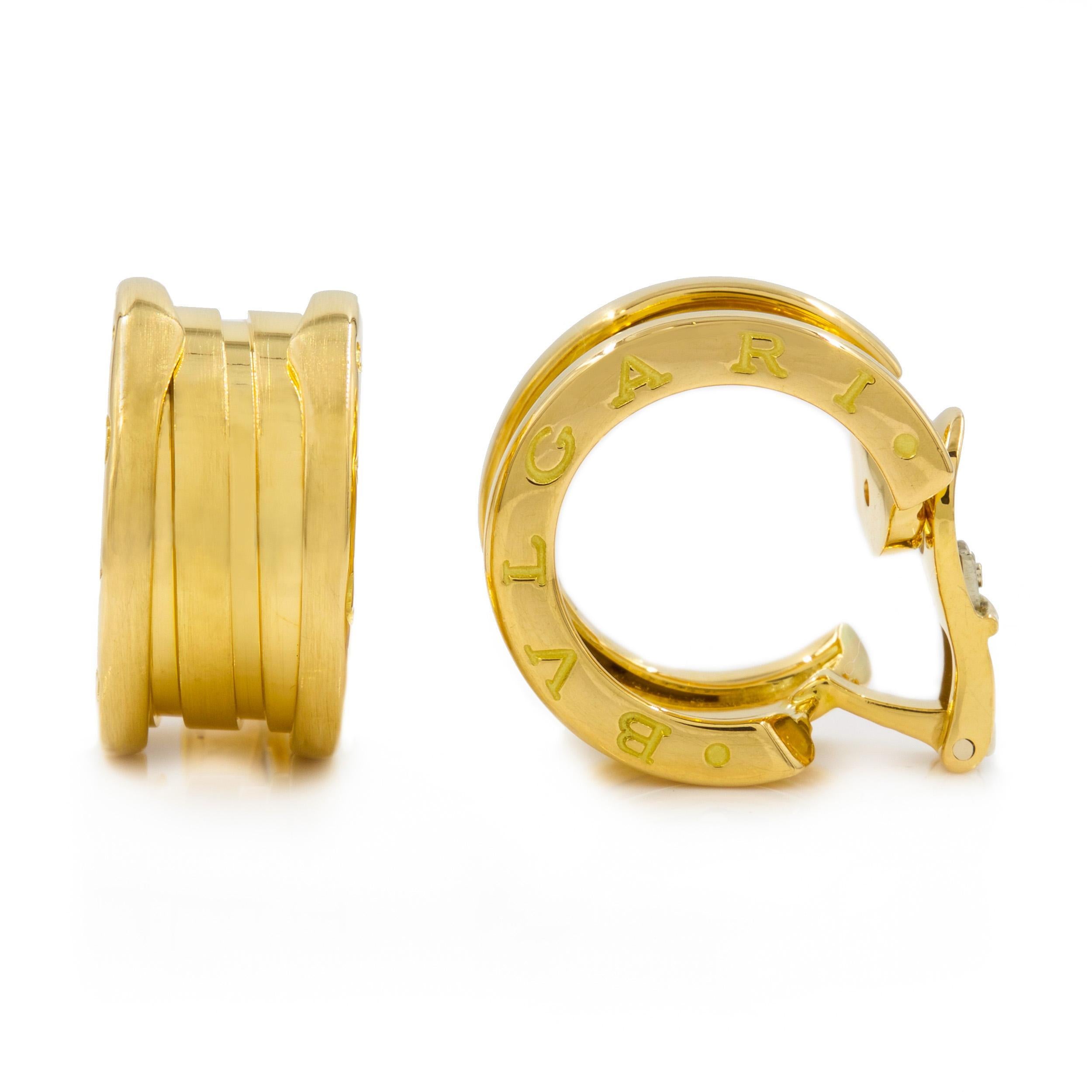 An iconic and classic form by Bvlgari, these B.Zero1 gold hoop earrings are positively gorgeous with a raised ridge interior hoop flanked by folded raised rims on either side engraved 