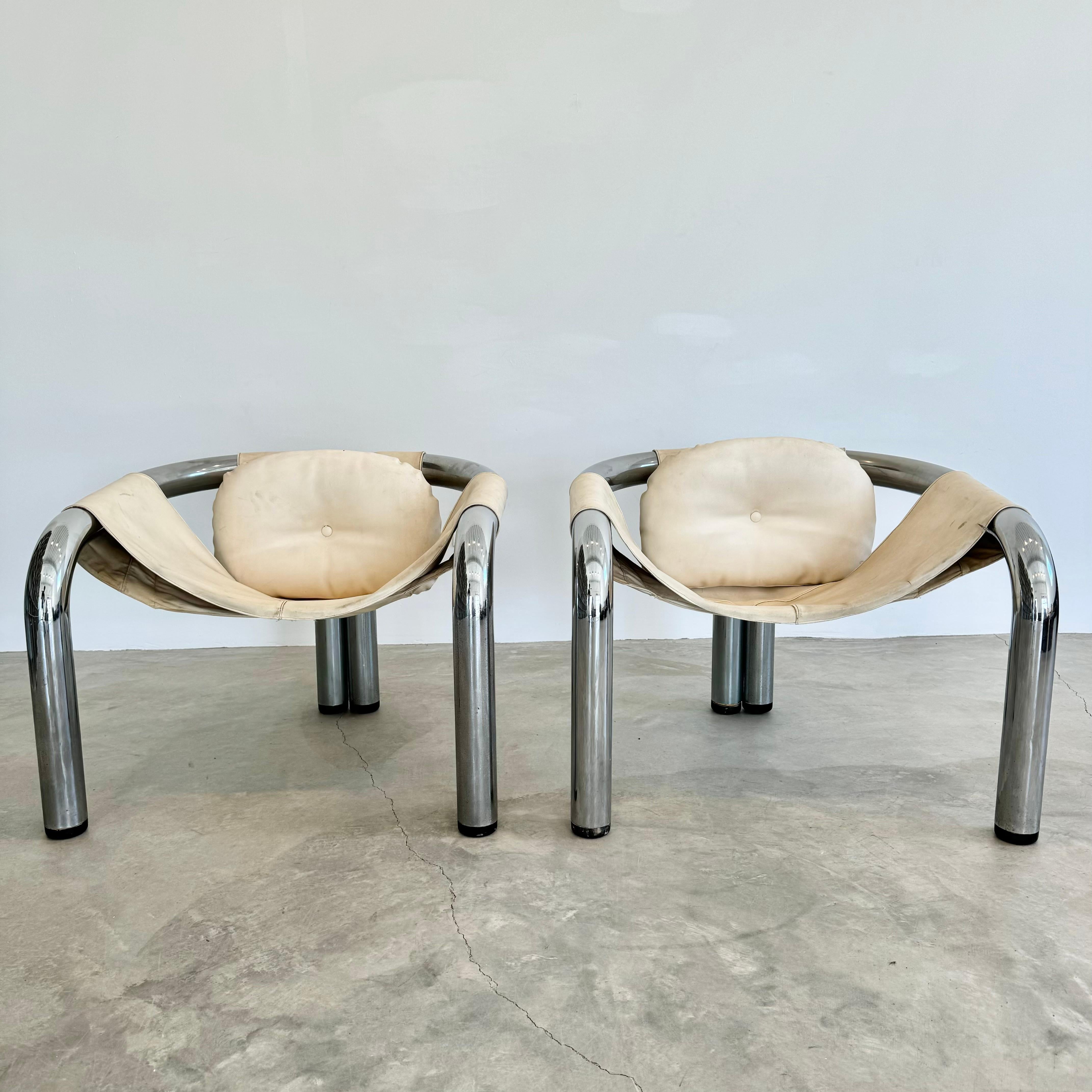 Important pair of armchairs by American designer Byron Botker. Large, tubular chrome frame makes a substantial and grounded seat. Synthetic upholstery with wear as shown. Completely original condition. Designed for Landes Manufacturing in the 
