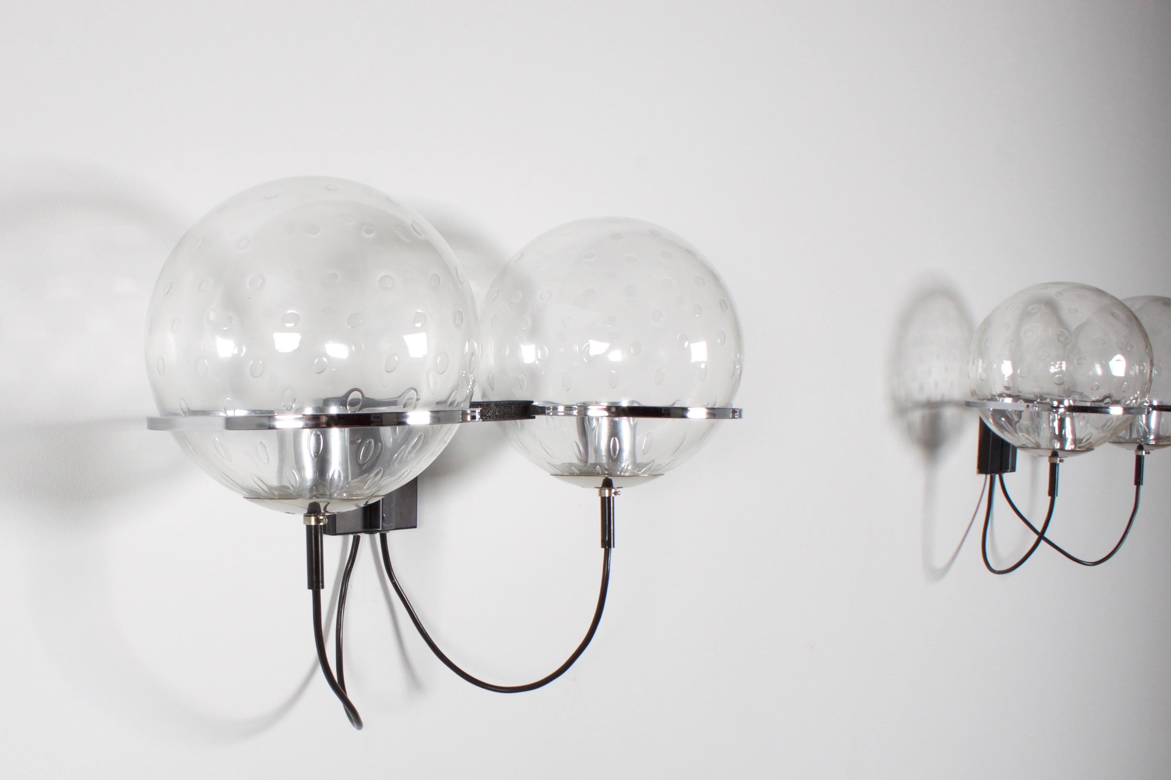Pair of impressive large C-1726 sconces by RAAK Amsterdam in very good condition.

Designed by Frank Ligtelijn in the 1960s 

Each lamp consists of a metal black frame with two chrome rings that hold two 25 cm / 9.85 Inch glass globes.

The