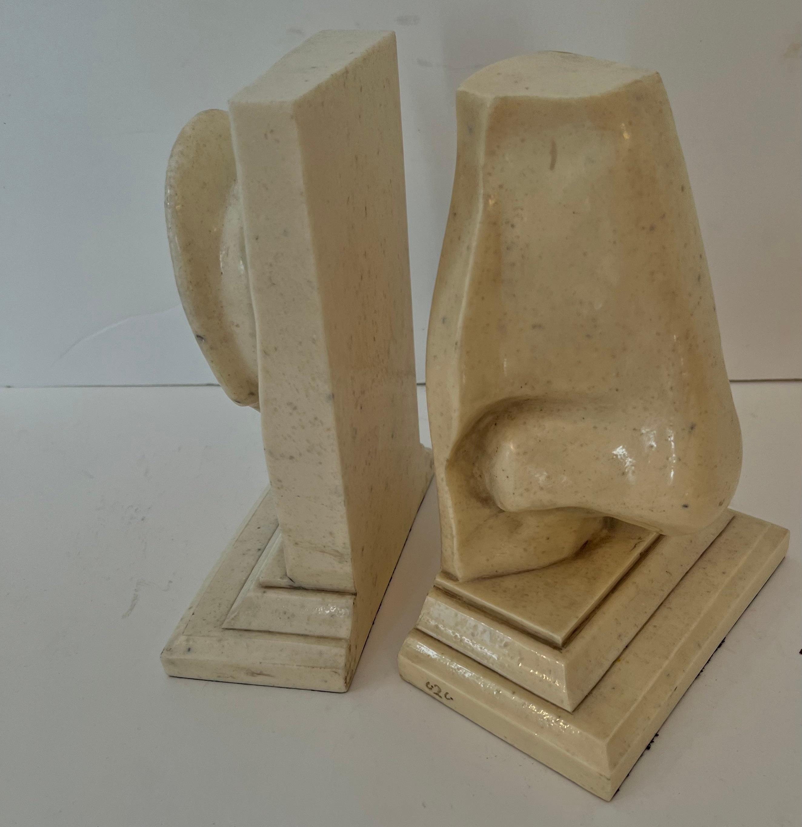 A wonderful pair of iconic C2 Design bookends. The pair combine a combination pop Nose and Ear. The resin has a stone look and are very popular. The pair are large and very impressive on a shelf or work station. If you are an ENT then they are the