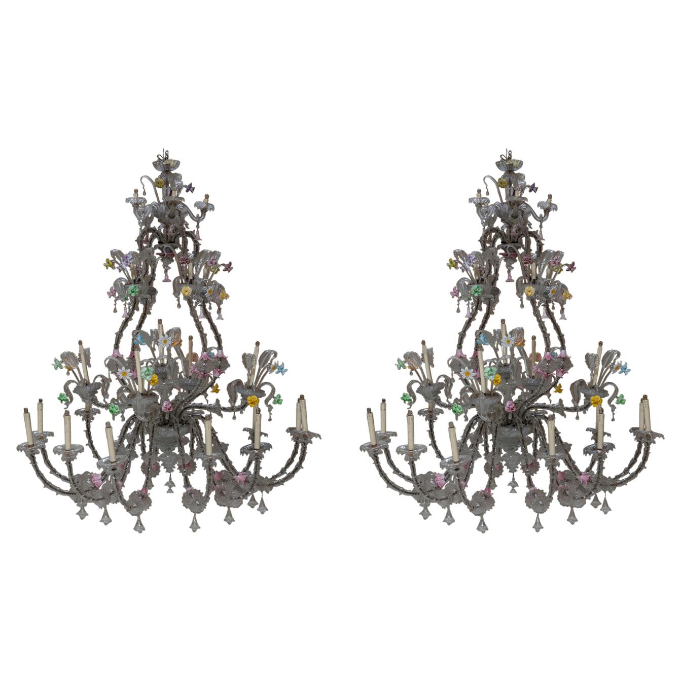 Pair of absolute magnitude and meticulously decorated details chandeliers Ca' Rezzonico by Venini.
The dimensions of the chandeliers are incredible as the precious decorations and colorful glass flowers. 
Each chandelier has 26 lights.