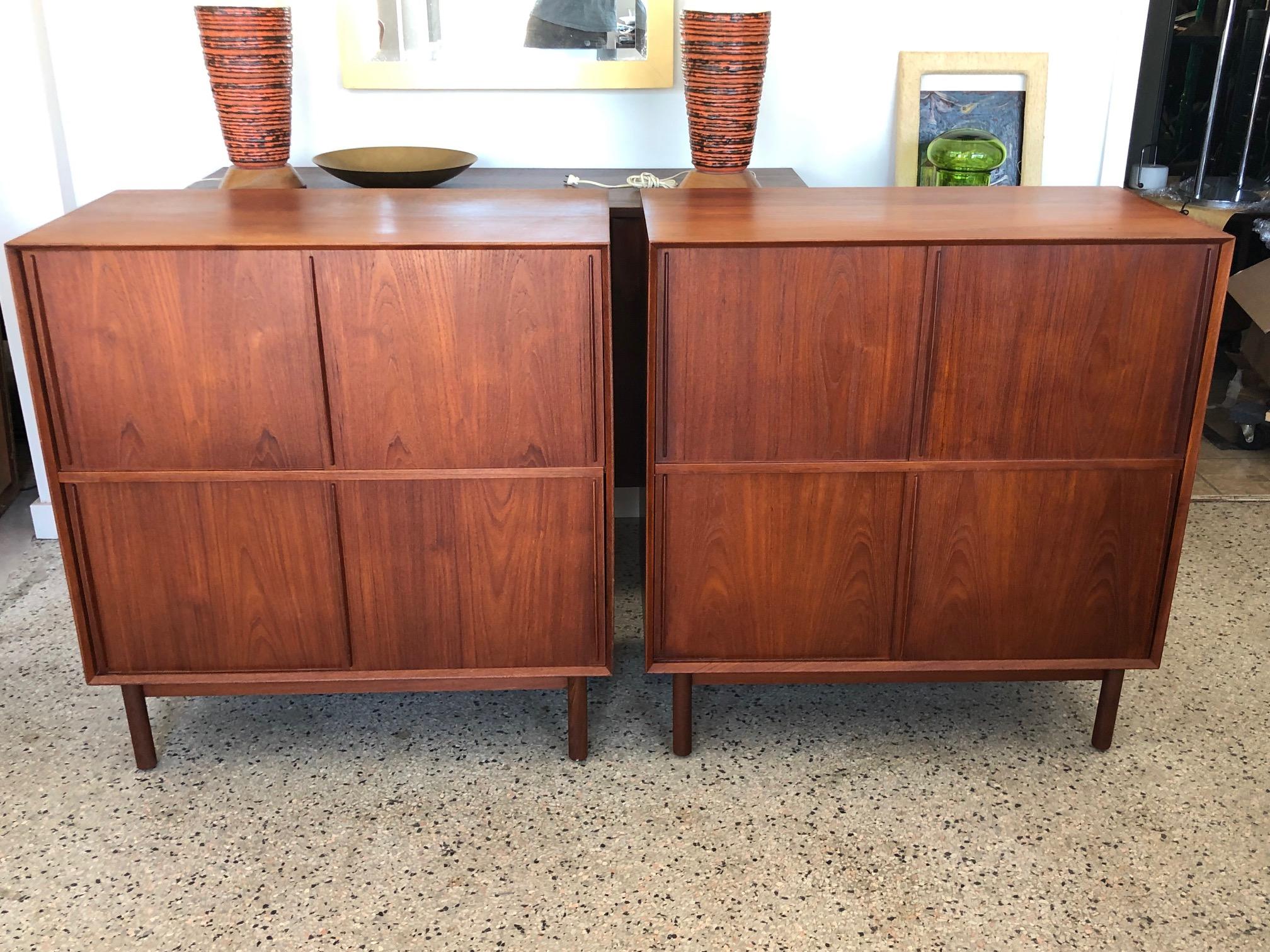A great pair of solid teak cabinets with sliding doors and adjustable shelves inside. Finger- jointed case on round legs. Designed by Hvidt and Mølgaard for Søborg Møbler in 1958. Made in Denmark. Very good original condition. Teak has beautiful