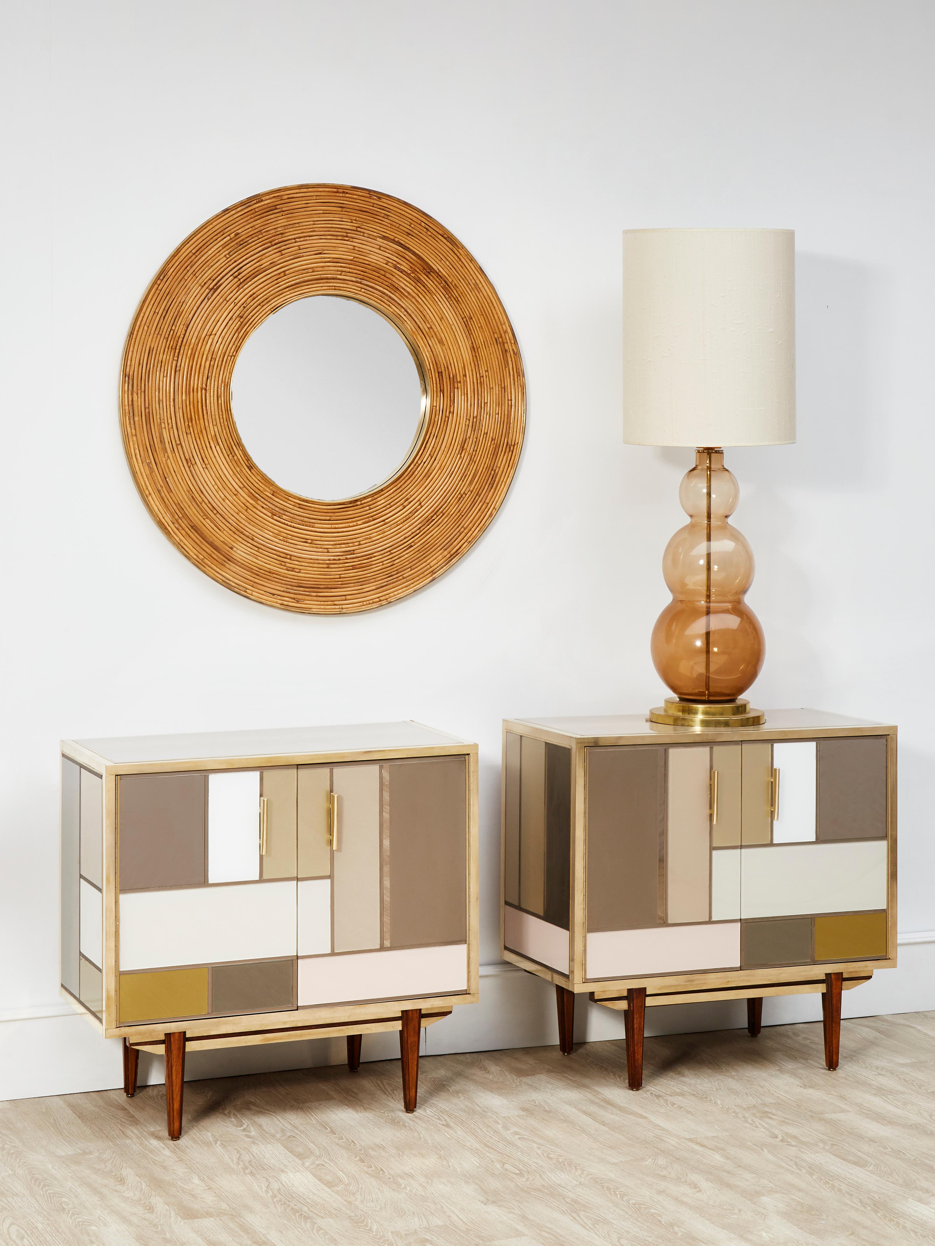 Pair of vintage wooden cabinets entirely restored and customized with tainted mirrors and brass inlays.
Italy, 1970s.
