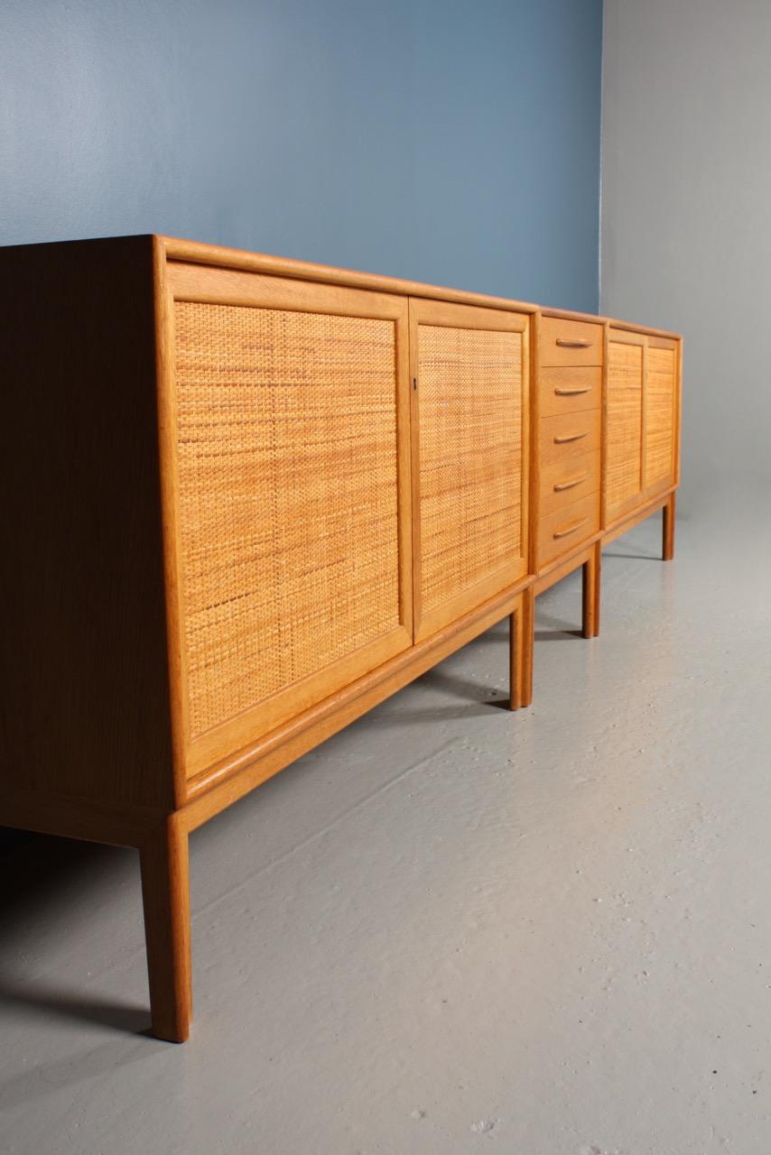 A chest of drawers and two matching cabinets in wax finished Scandinavian oak, cane panels designed by MAA. Alf Svensson and made by Bjästa cabinetmakers, Sweden. Great original condition.
 
Measures: Cabinet W 120, D 45, H 72 cm
Chest of drawers